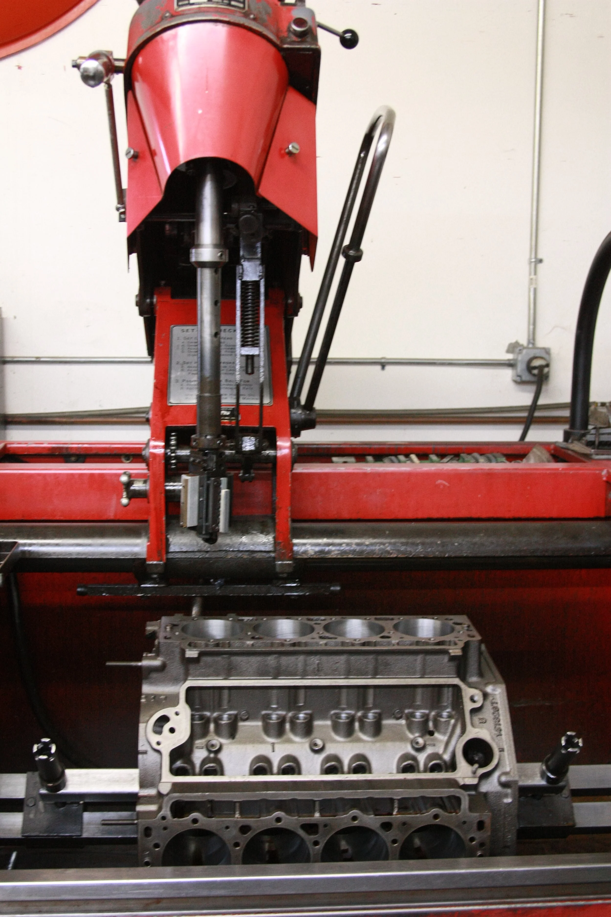 Sunnen Honing machine working on an engine block, in automotive machine shop.