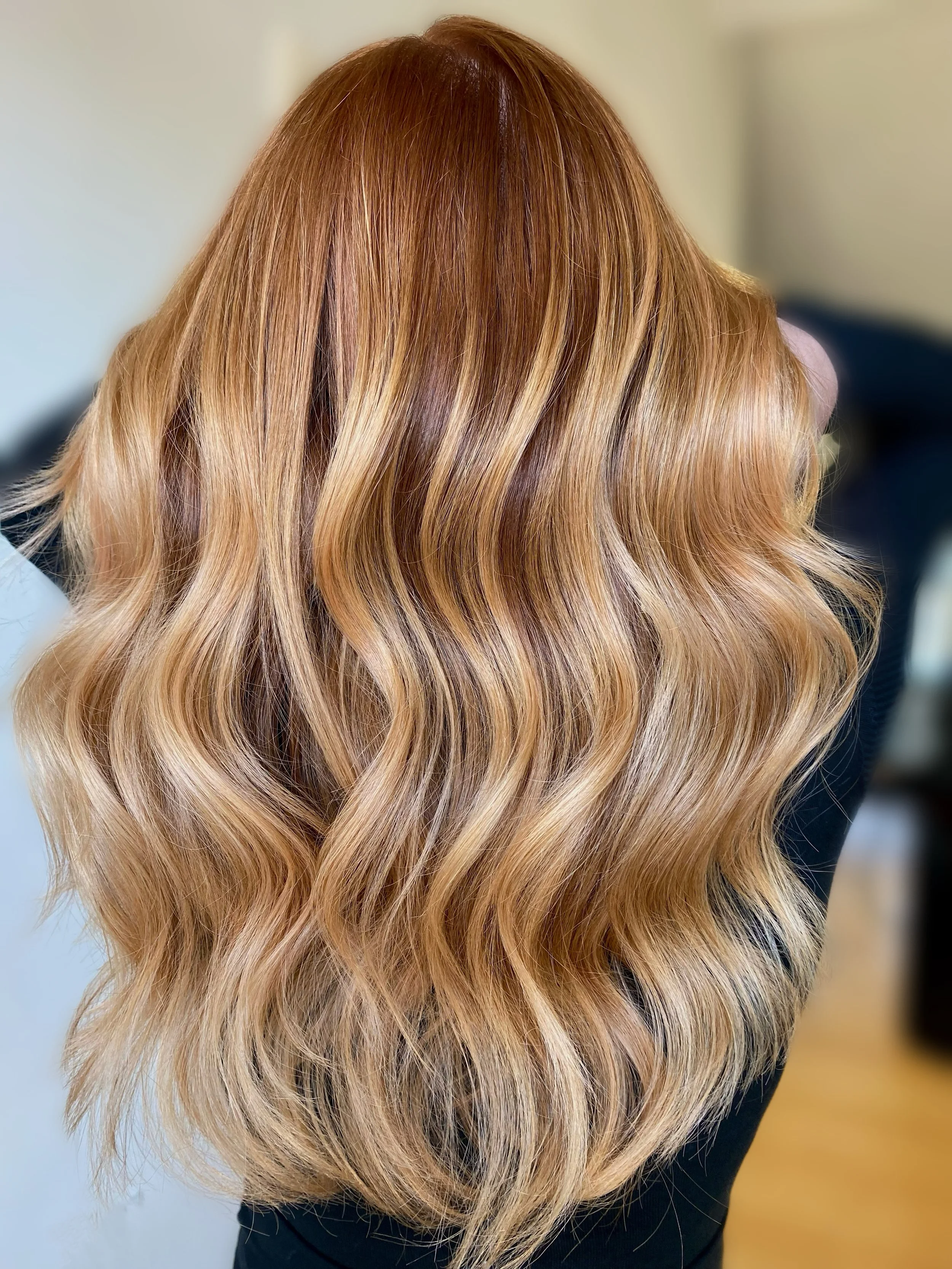 Close-up of long, wavy, blonde hair with subtle highlights.