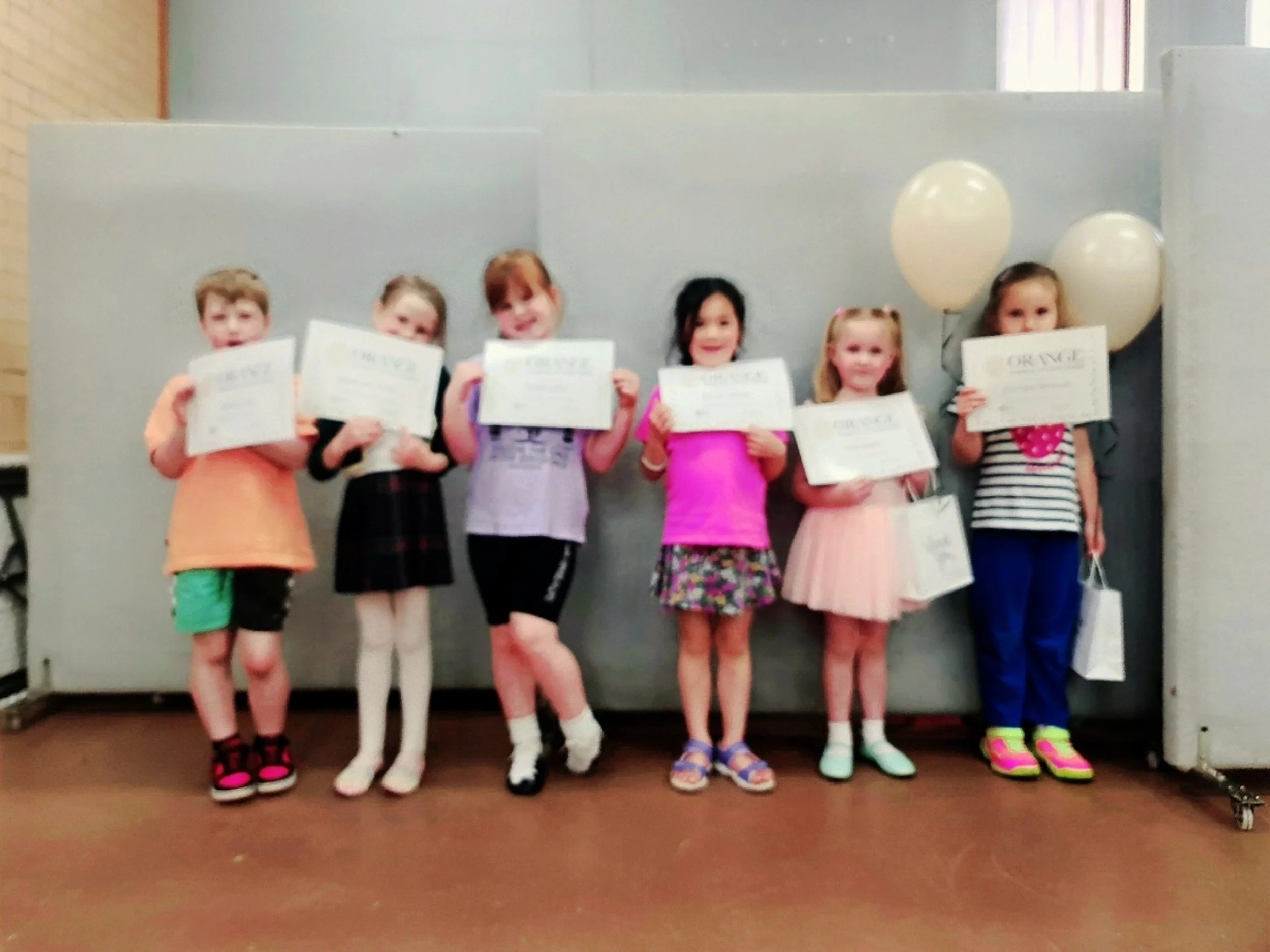 Beginner students from Orange Academy of Irish Dance proudly holding their certificates, celebrating achievement, confidence and progress in a supportive dance environment in Orange, NSW.