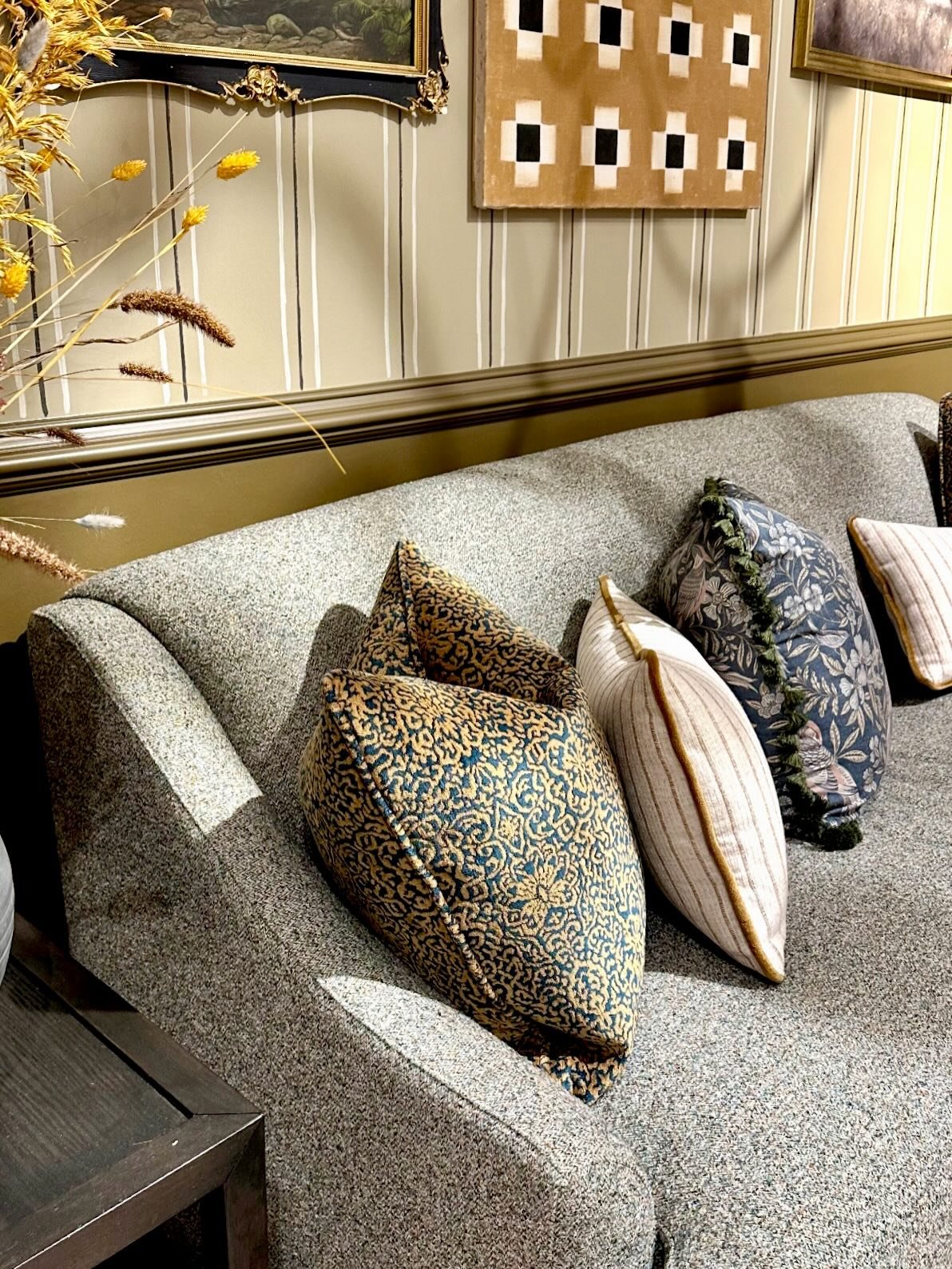 By blending layered fabrics and tailored furniture with personal art pieces, this room masters the art of contrast. 

The hand-painted, slightly irregular stripes on the walls balance the more formal decor, proving that the ultimate goal isn&rsquo;t 