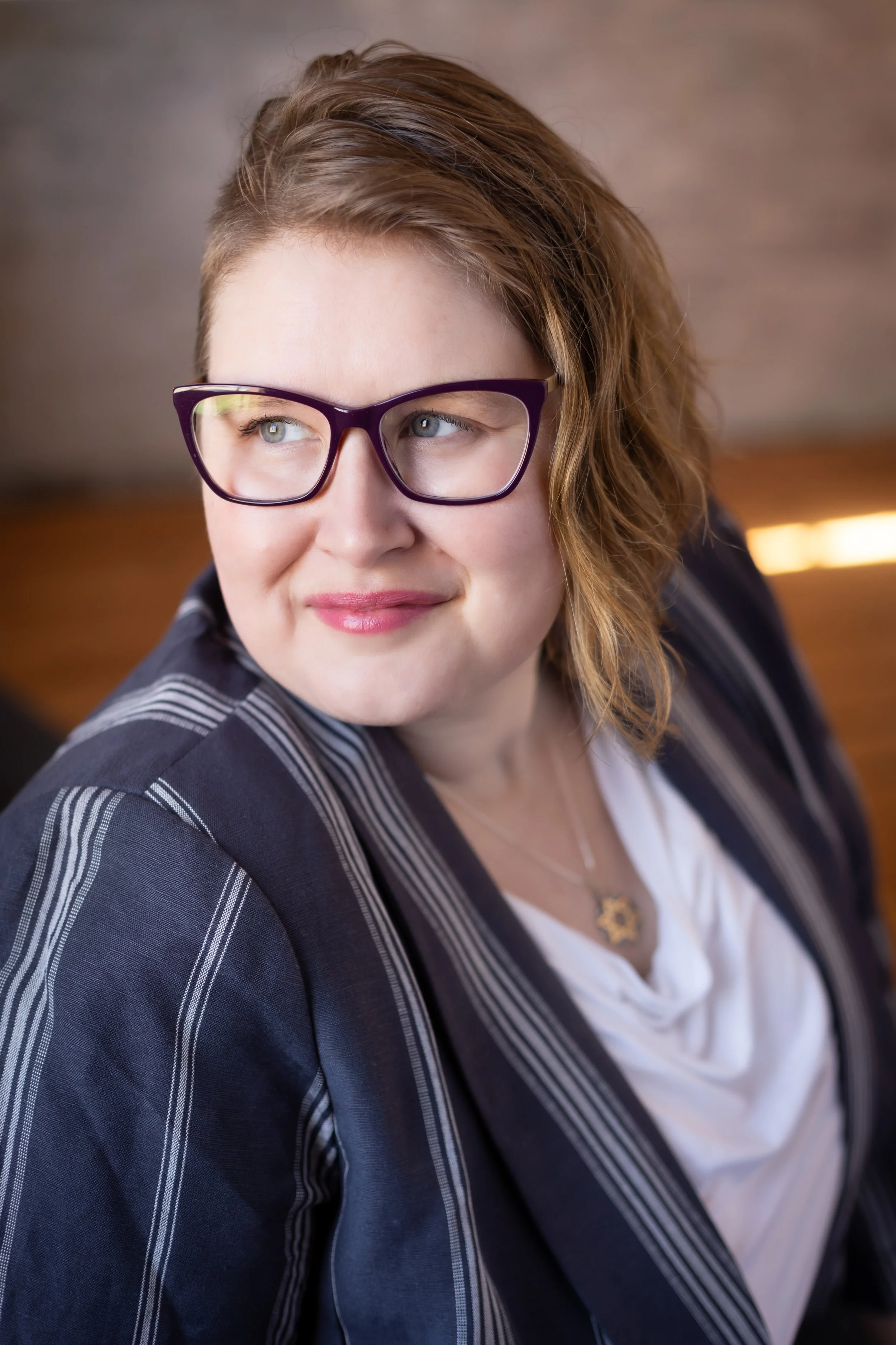 Profile of Ursa Scherer, looking confident and poised.