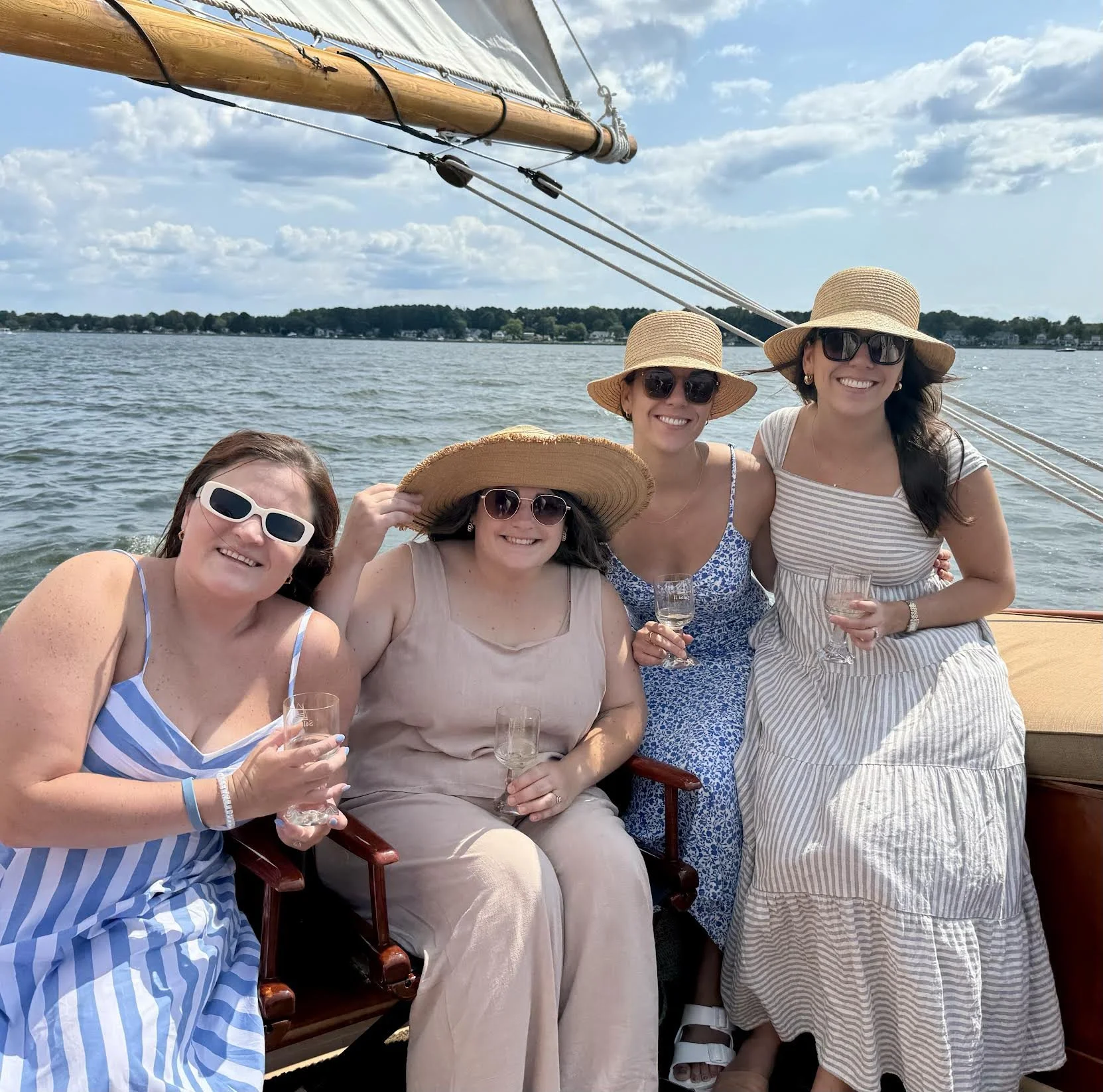 Group of friends enjoying a luxury private sailing adventure aboard Sail Selina NY yacht near Shelter Island, New York, with calm waters and clear skies