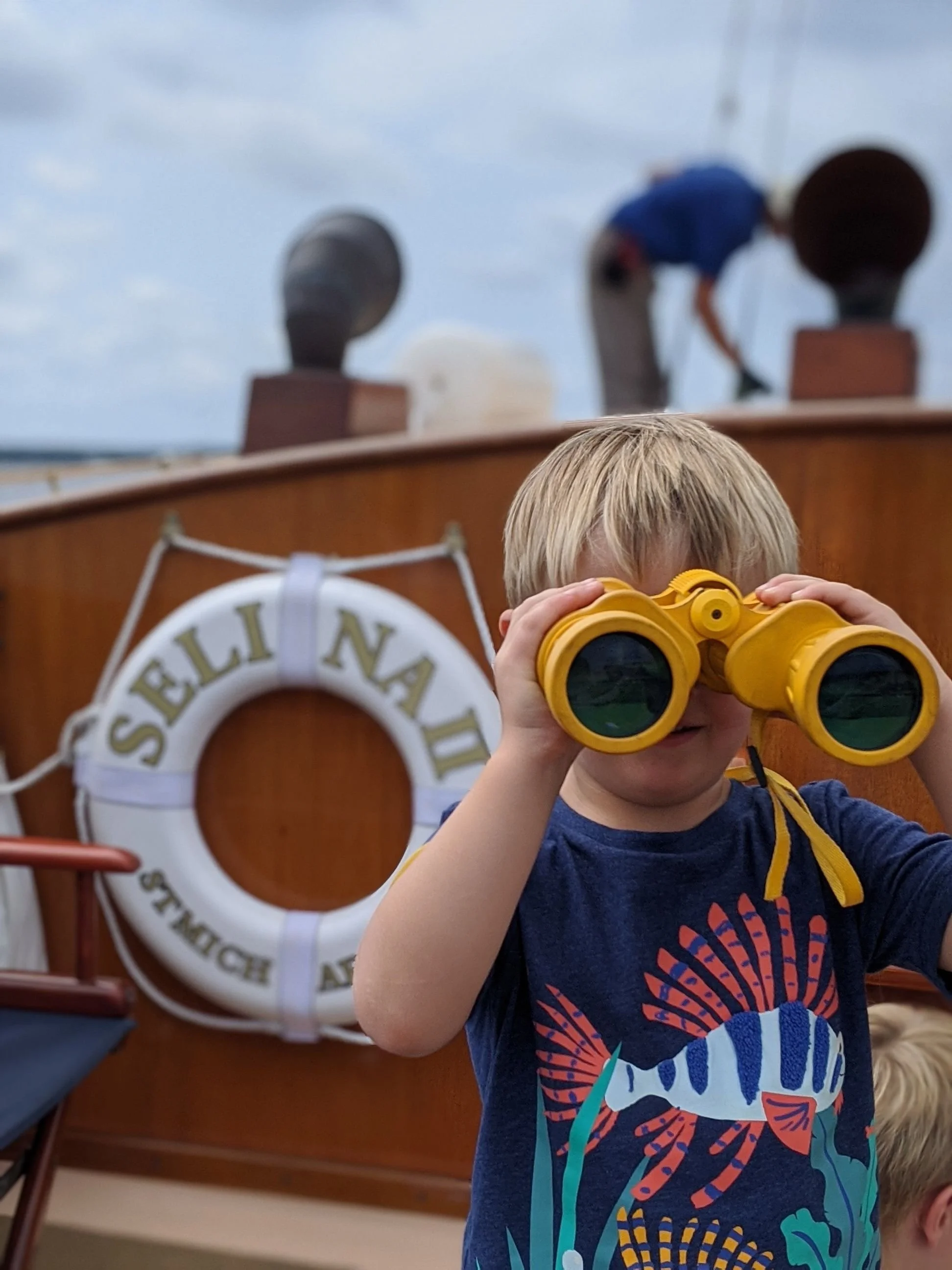 A curious young crew member aboard Selina II searching for adventure.