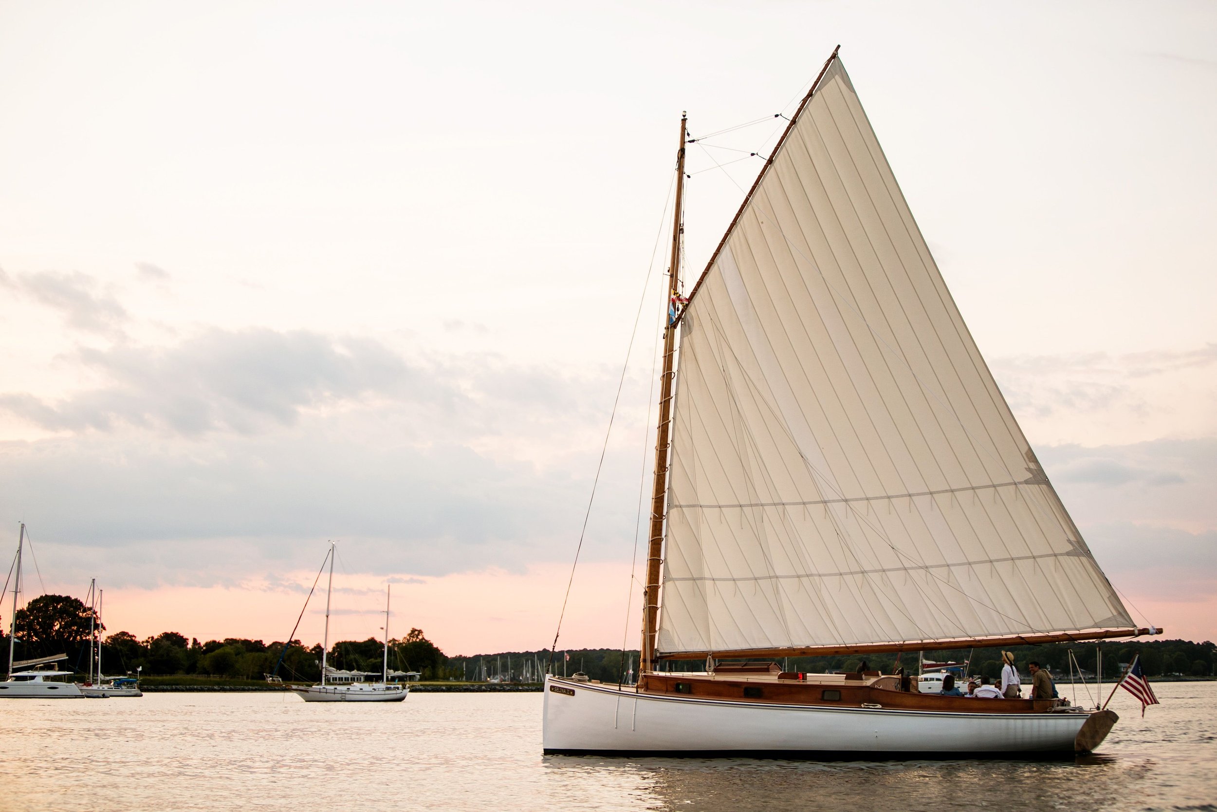 Beautiful sunset photo of Sail Selina II. Showcases what your cruise aboard this historic ship could look like.