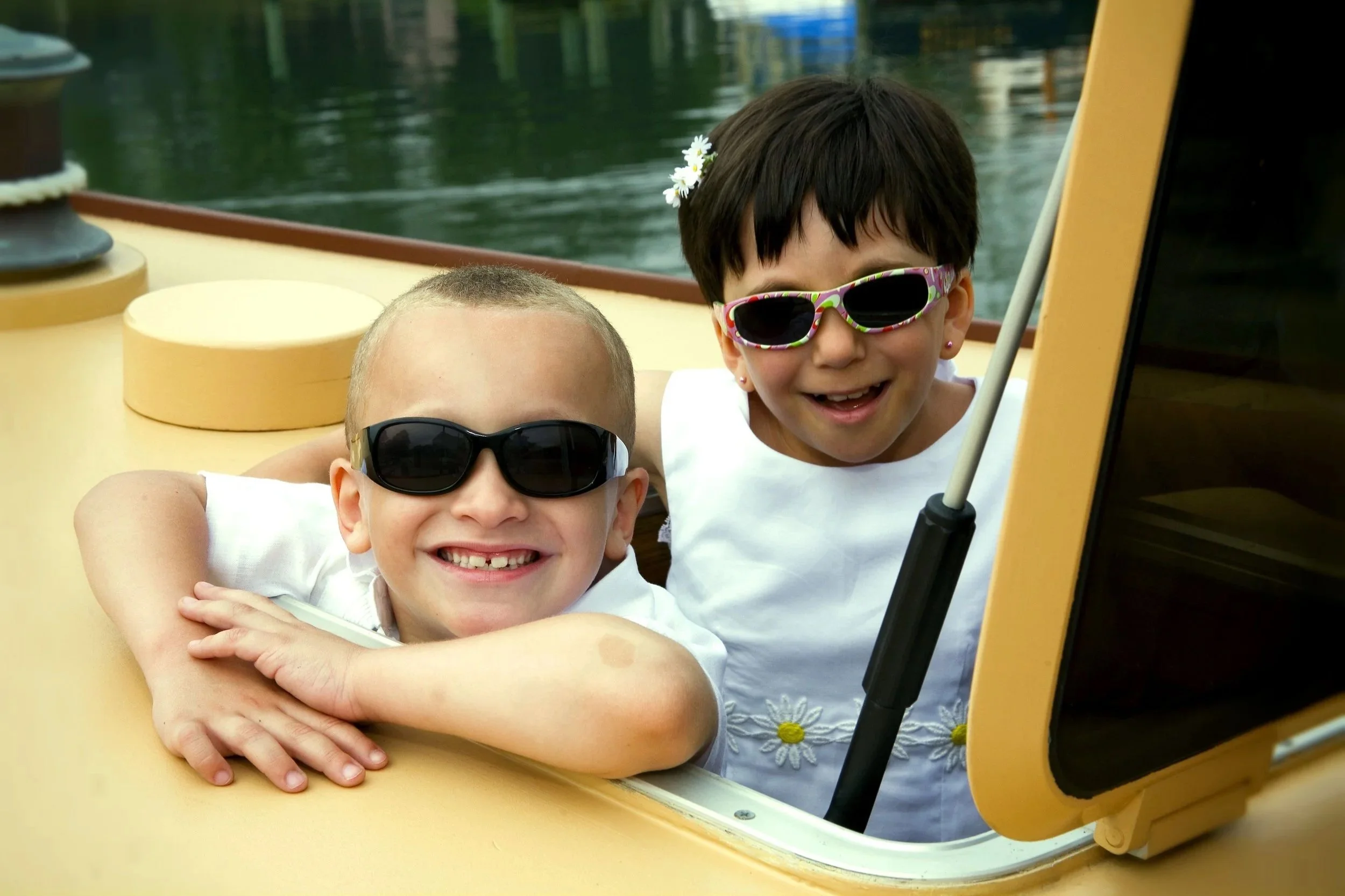 Happy kids enjoying a private sailing adventure aboard Sail Selina NY yacht, the Selina II, on calm waters near Shelter Island, New York.