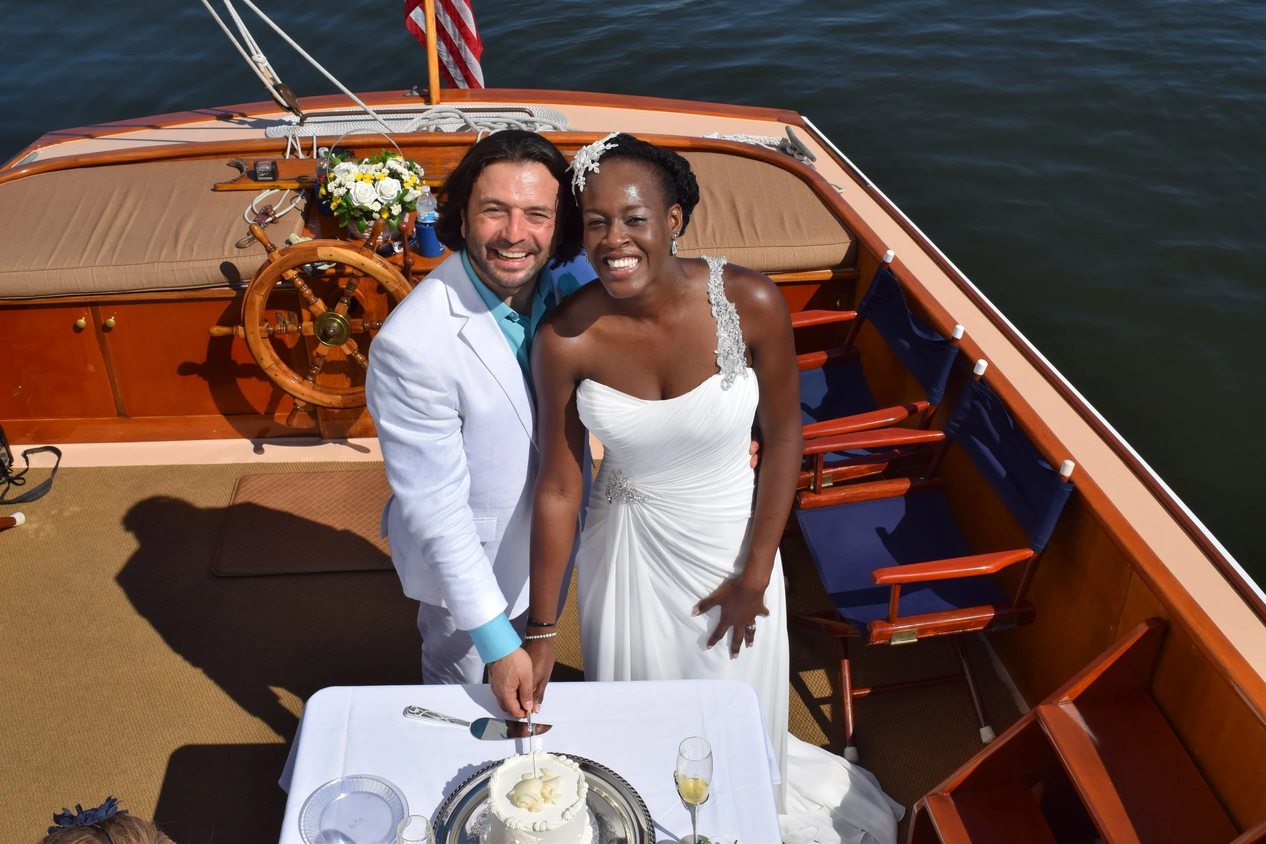Newlyweds cutting their cake aboard Selina II as part of their Nautical Wedding Package.
