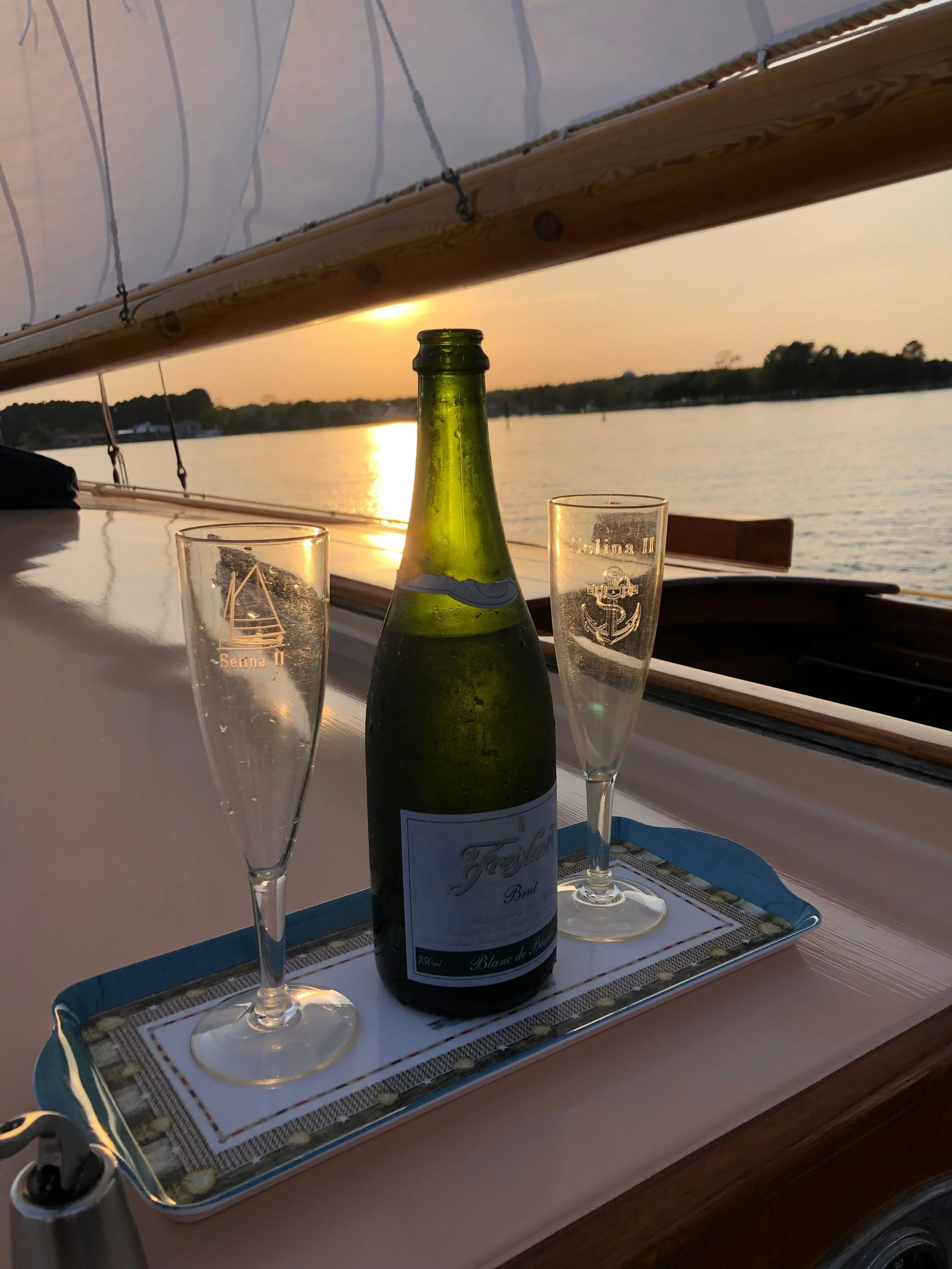 Two beautiful custom Selina II champagne glasses with a gorgeous sunset in the background.
