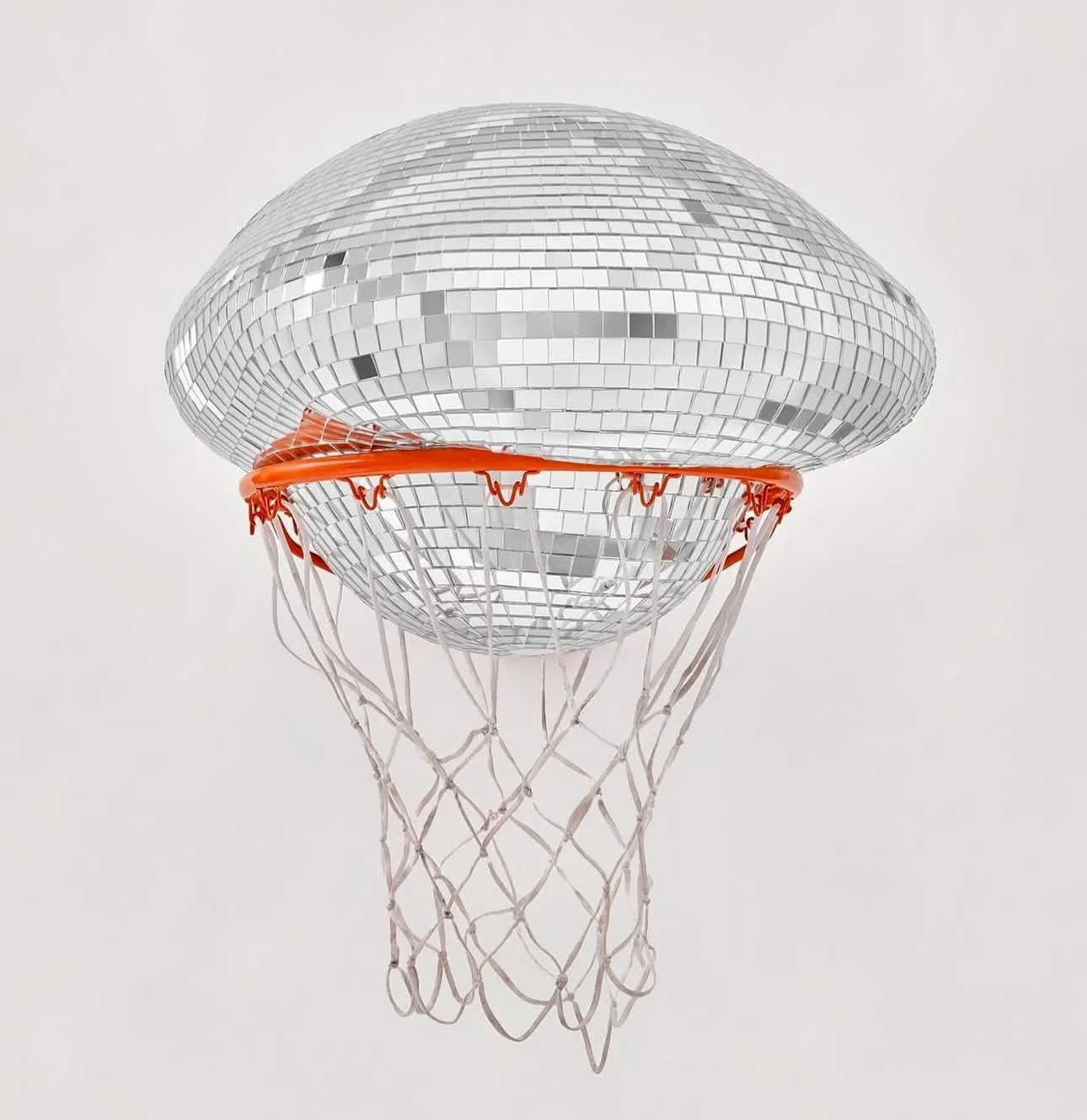 A basketball hoop with a disco ball as the backboard, featuring a metal rim, orange net, and white mesh netting.