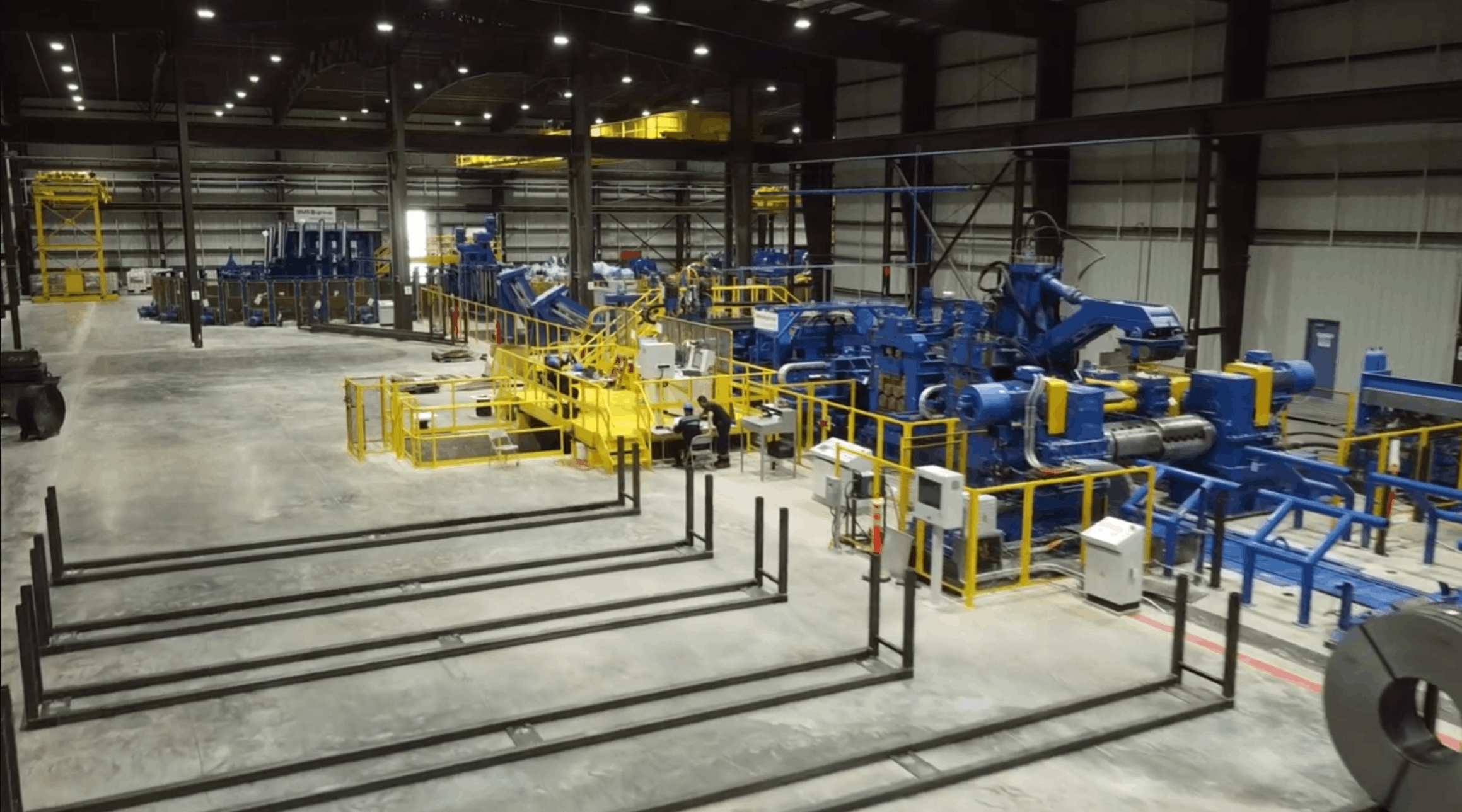 Close-up of automated industrial machinery and metal processing equipment.