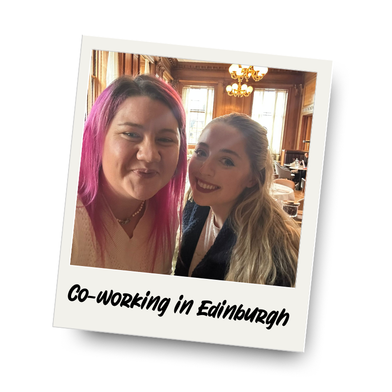 Two women smiling and posing for a photo in a wooden-paneled room with large windows and chandeliers, labeled 'Co-working in Edinburgh'.