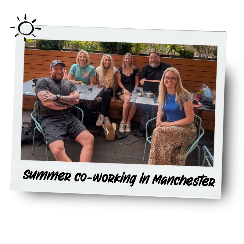 A group of six people sitting at outdoor tables, smiling and enjoying each other's company. They are in a backyard with a wooden fence and greenery in the background. The photo has a caption that reads 'SUMMER CO-WORKING in Manchester.'
