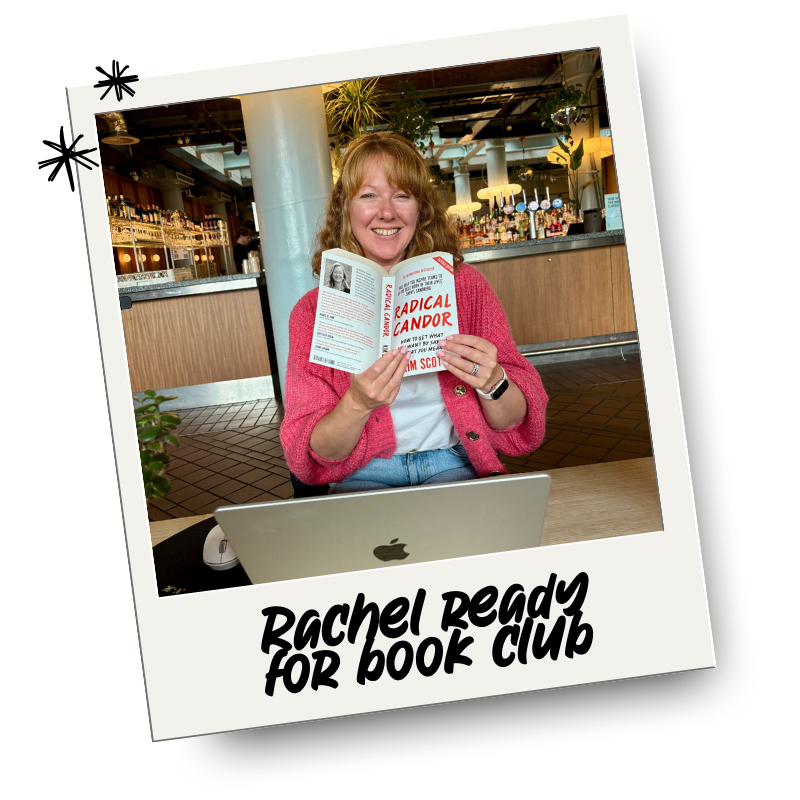 A woman with red hair, wearing a pink cardigan and white shirt, sitting at a table in a cafe or restaurant, reading a book titled "Radical Candor". She is smiling and has a laptop in front of her. The image is styled to look like a Polaroid photo with the caption "Rachel Ready for Book Club."