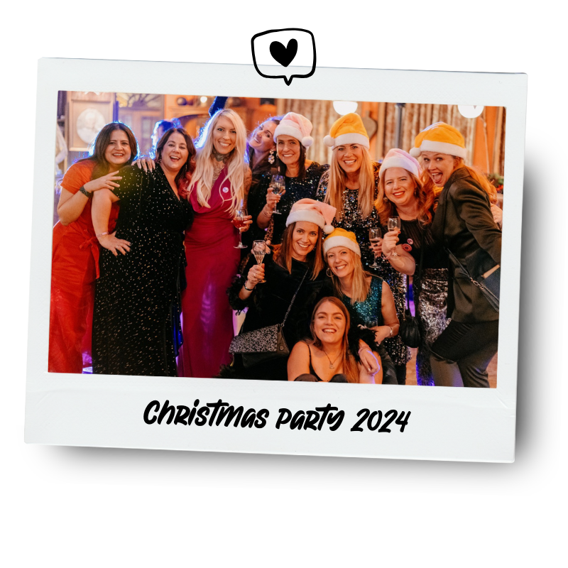 Group of women wearing Santa hats celebrating at a Christmas party, with festive decorations and drinks, labeled 'Christmas Party 2024'.