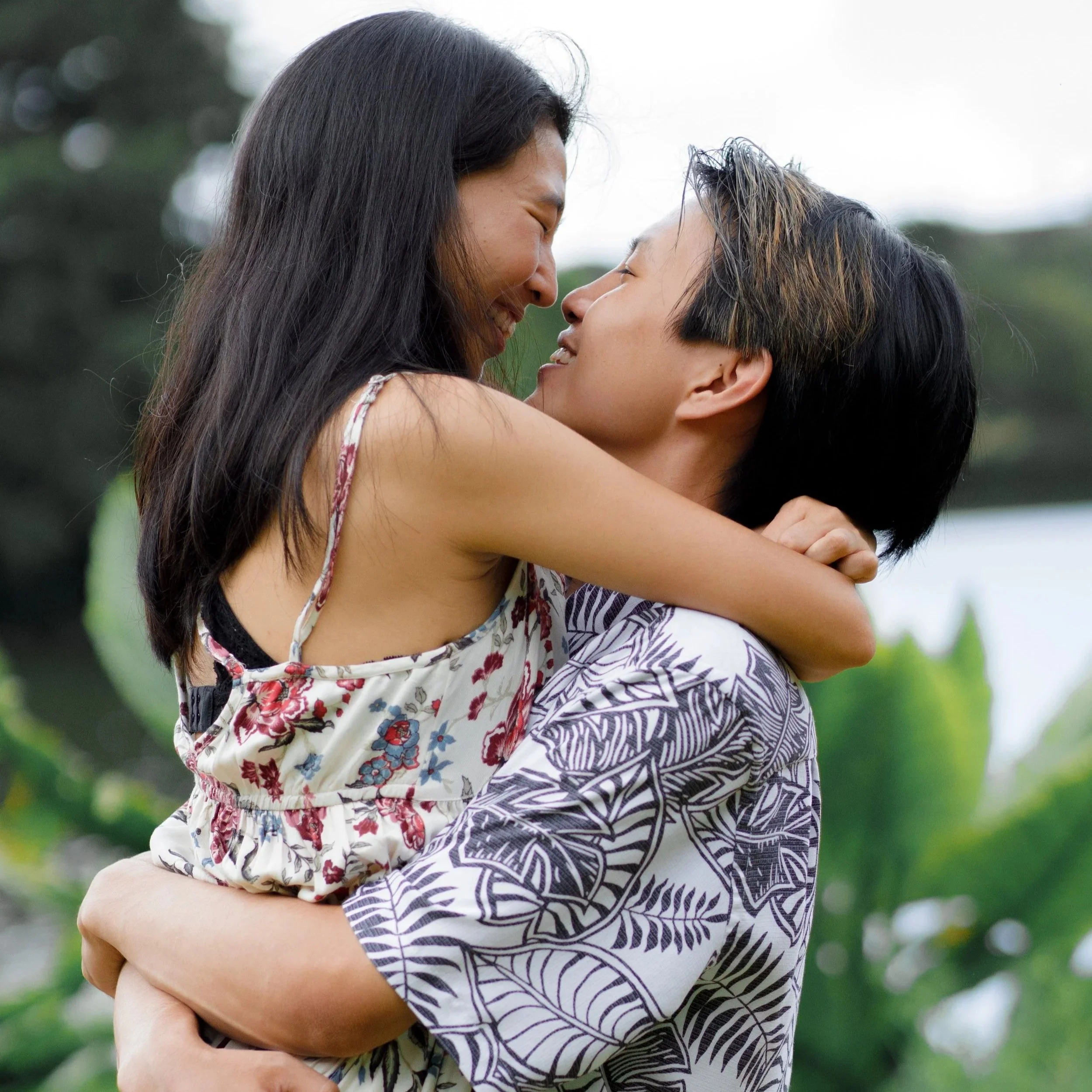 Candid outdoor portrait of a couple hugging and smiling