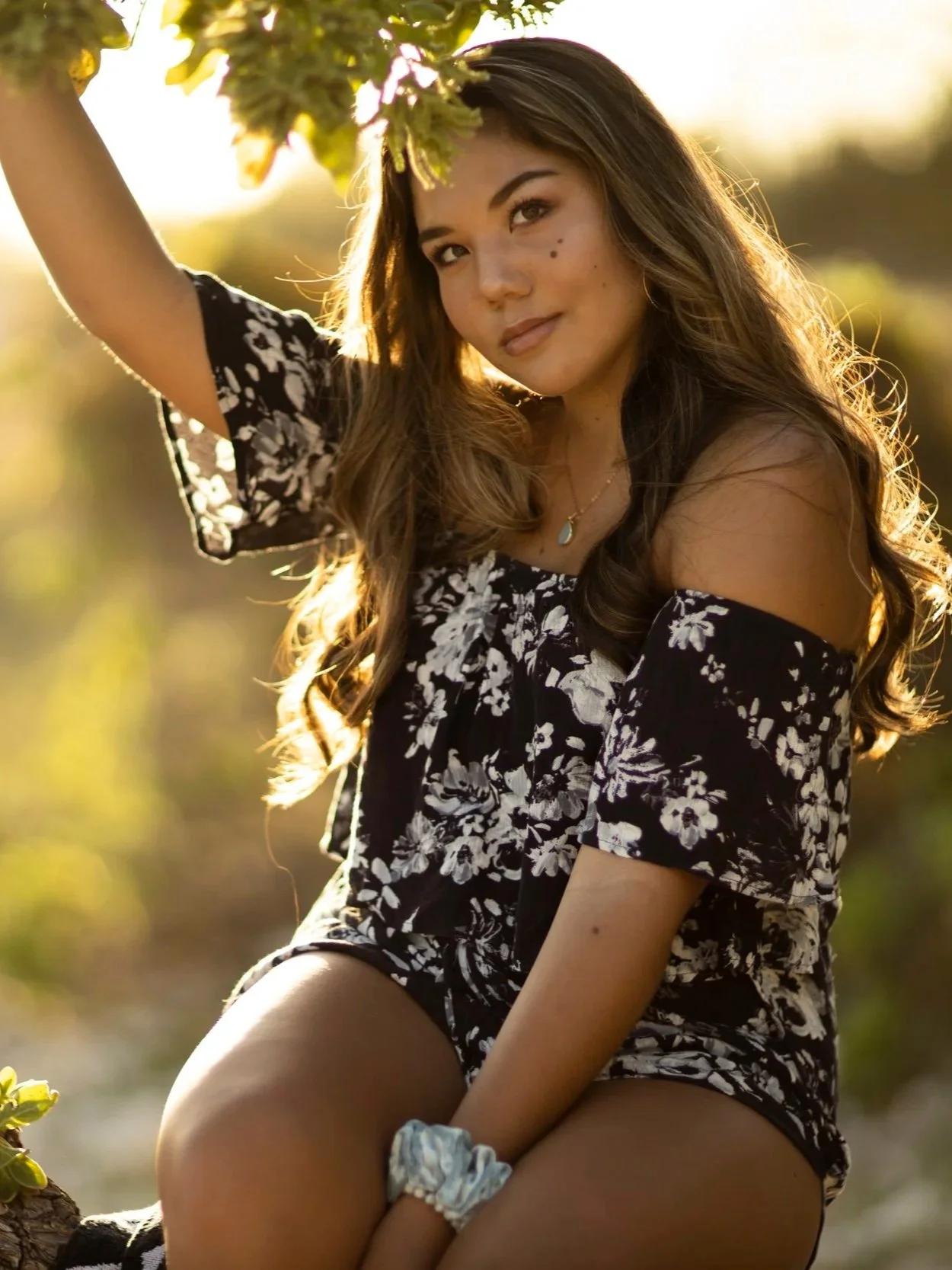 Lifestyle graduation portrait of a woman photographed at sunset