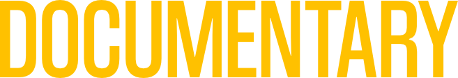 Close-up of the word 'DOCUMENTARY' displayed in large, bold yellow letters on a black background.