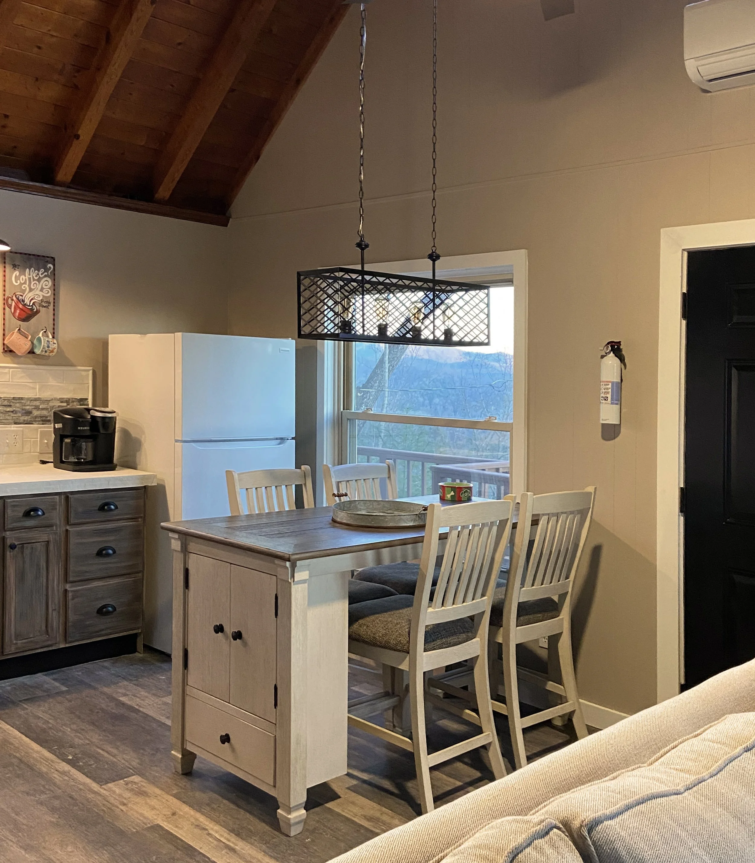Stained the vaulted ceiling and painted the dark brown panelling to update this Air B&B kitchen.