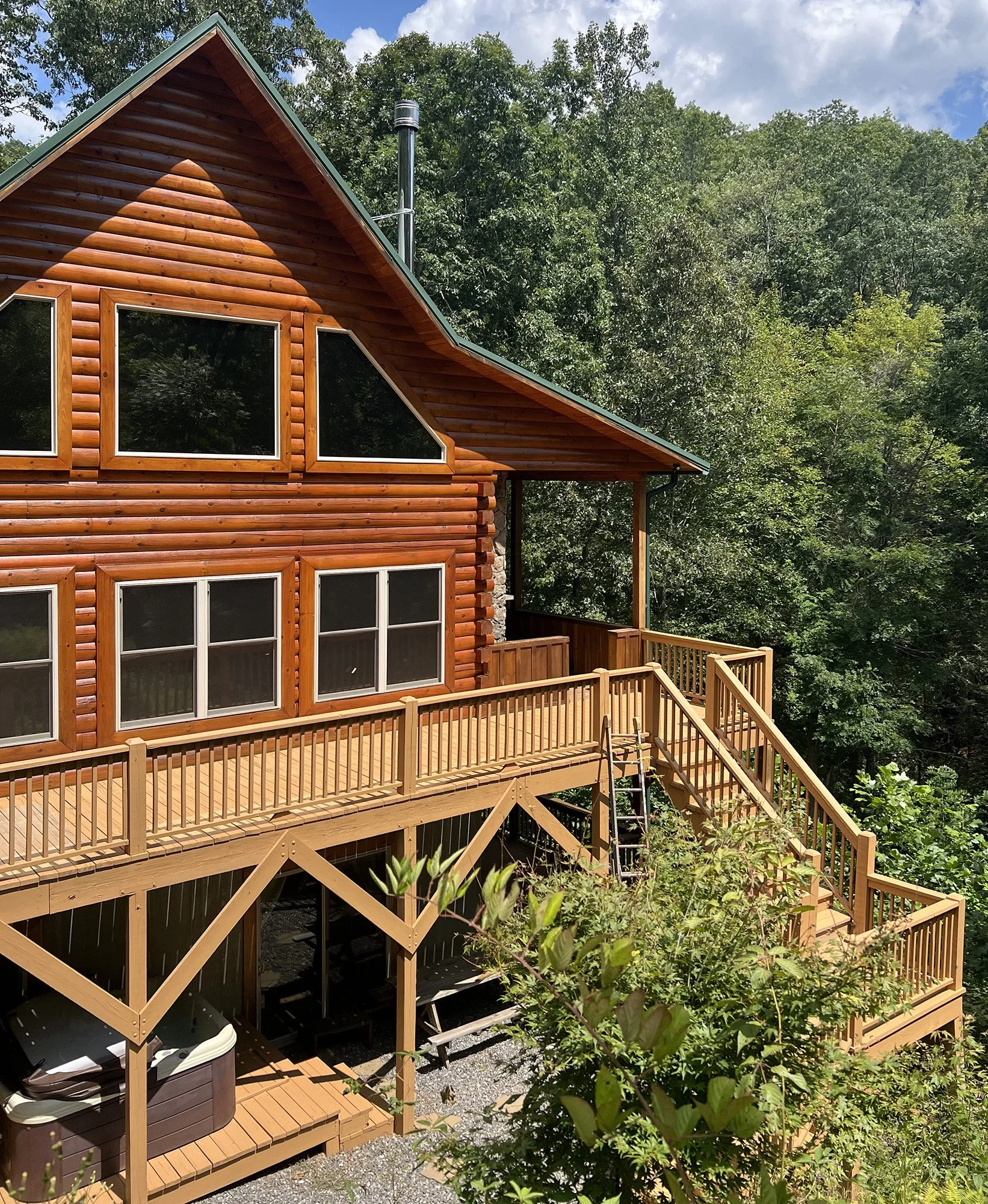 deck and stairs of log house after staining
