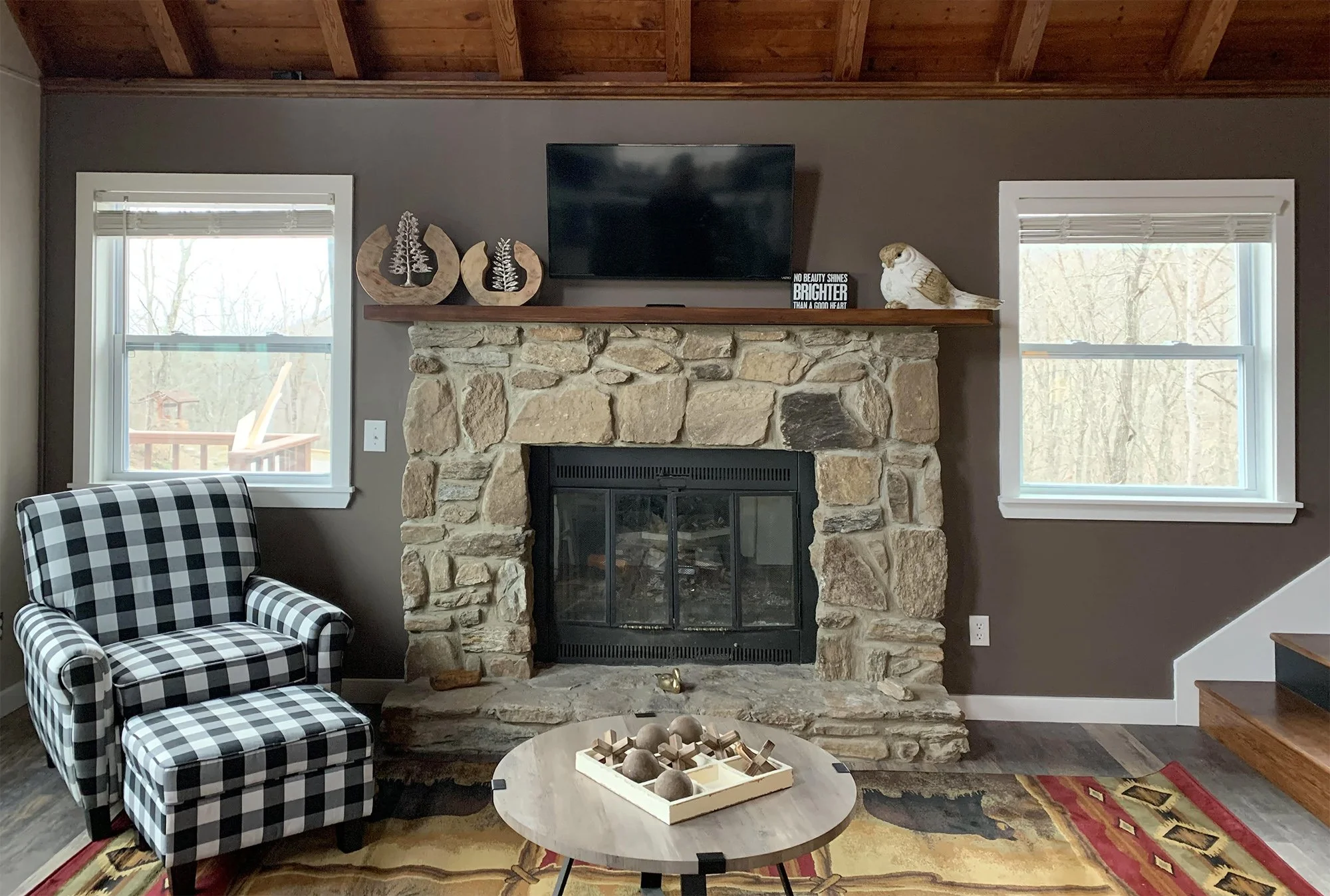 Rustic, cozy den theme with pewter walls emphasize the wood, stone and furniture.