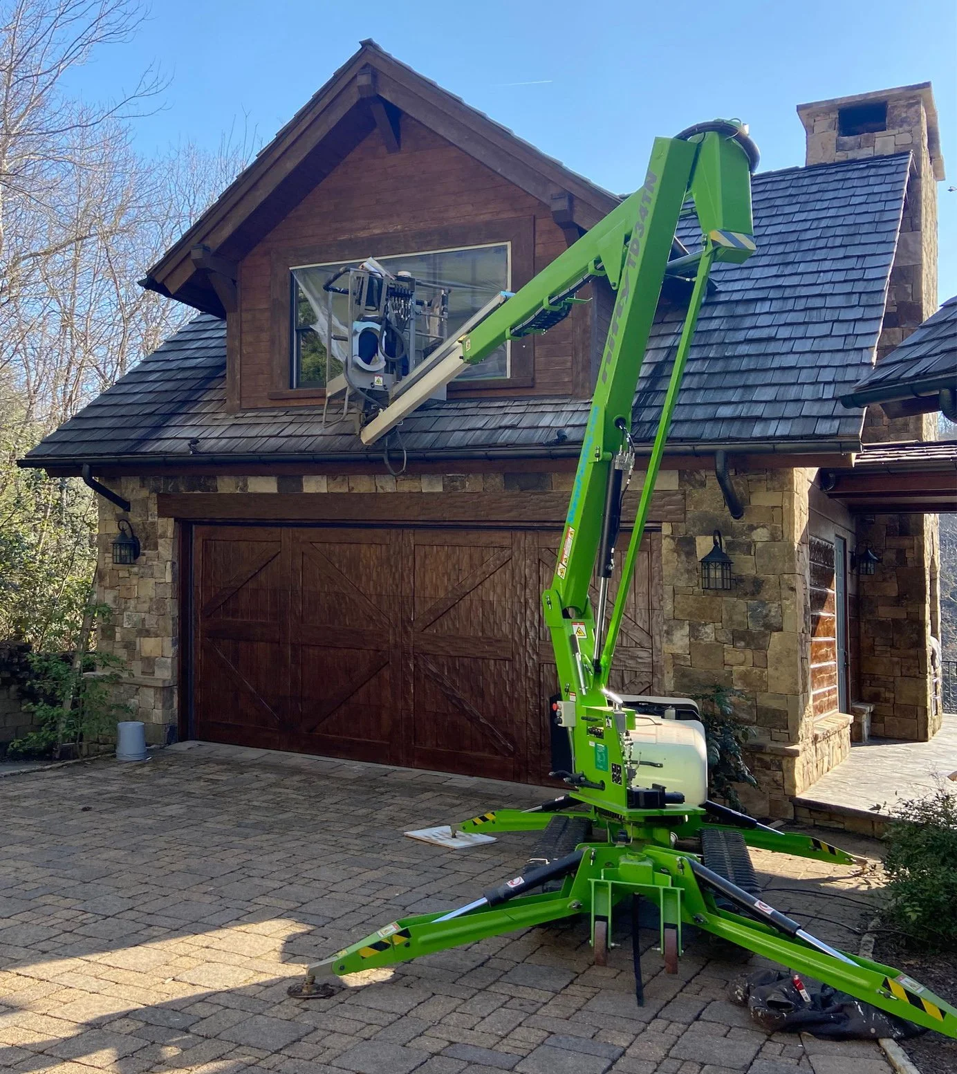 NiftyLift Man lift used to reach 2nd floor dormer window on roof edge