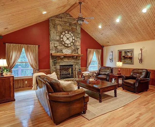 wood and stone living room with red accent wall