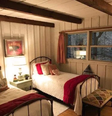 Warm glow of light in the evening of a bedroom of a cabin.