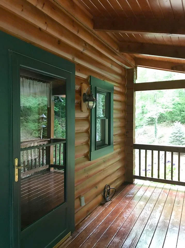 Stained logs, porch ceiling, deck boards and handrails, as well as painted all the trim and doors.