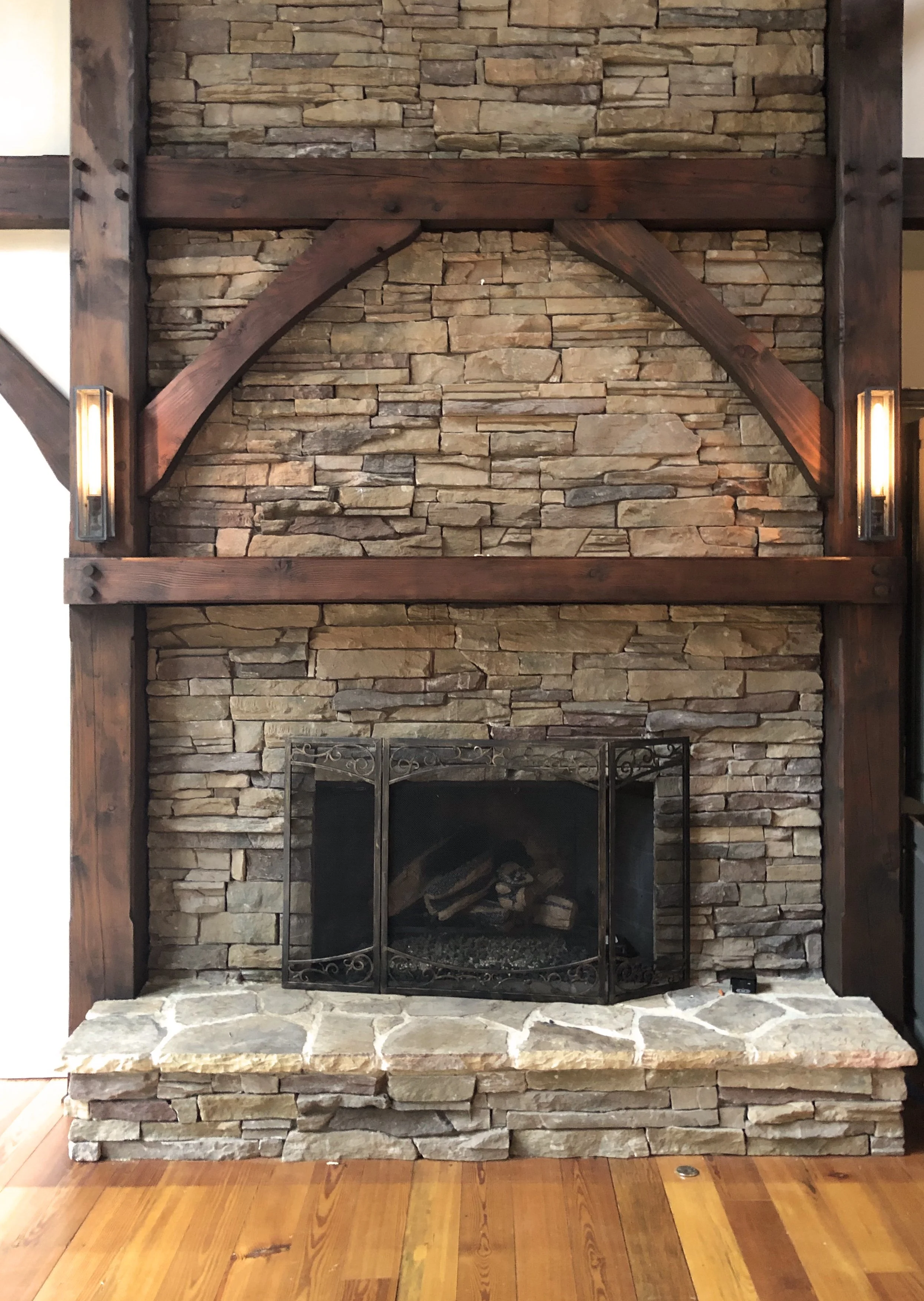 Stained the wood and painted the walls around the large stone fireplace in the living room of a home in Cashiers, NC.