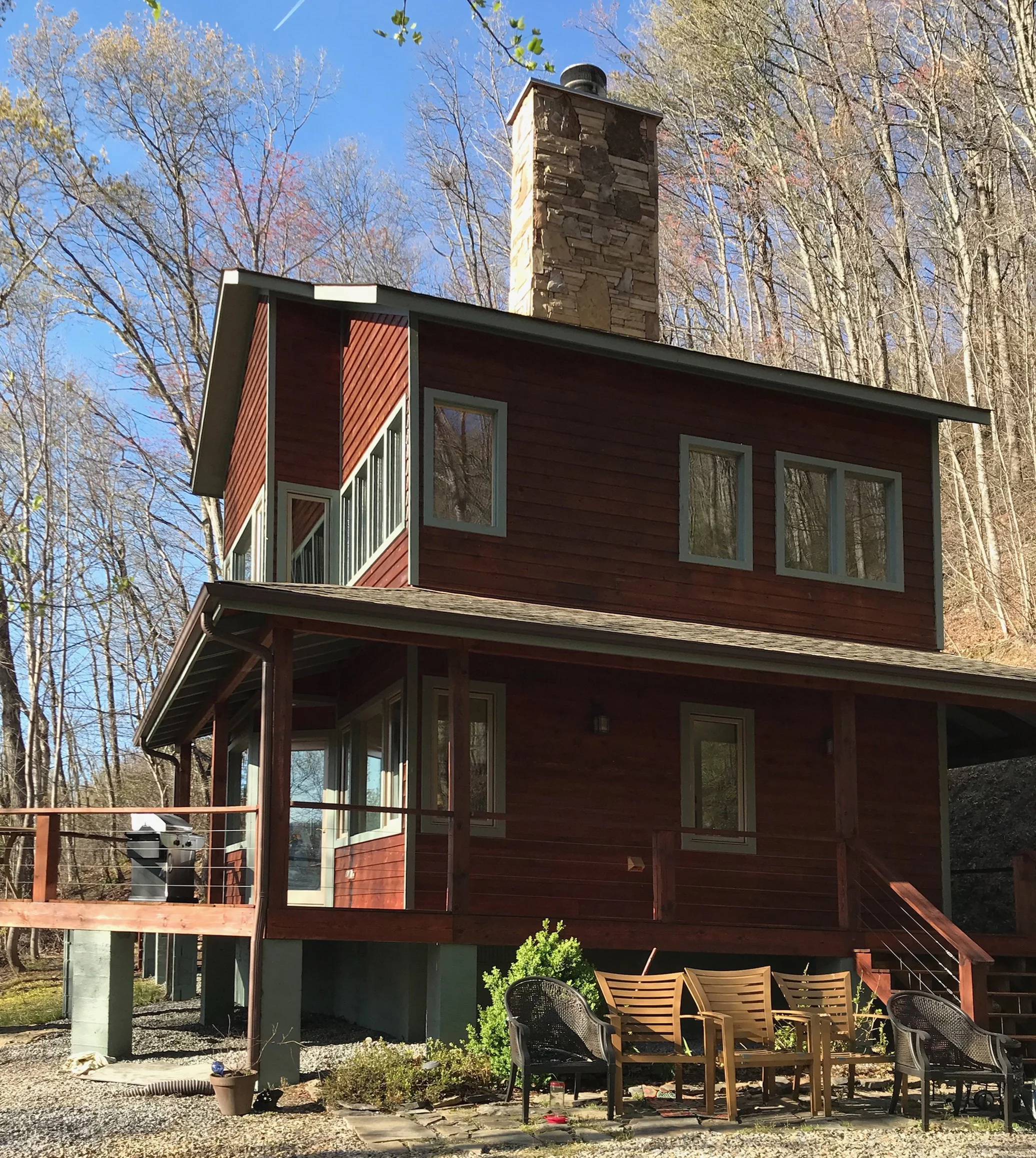 Red two-story mountain cabin.