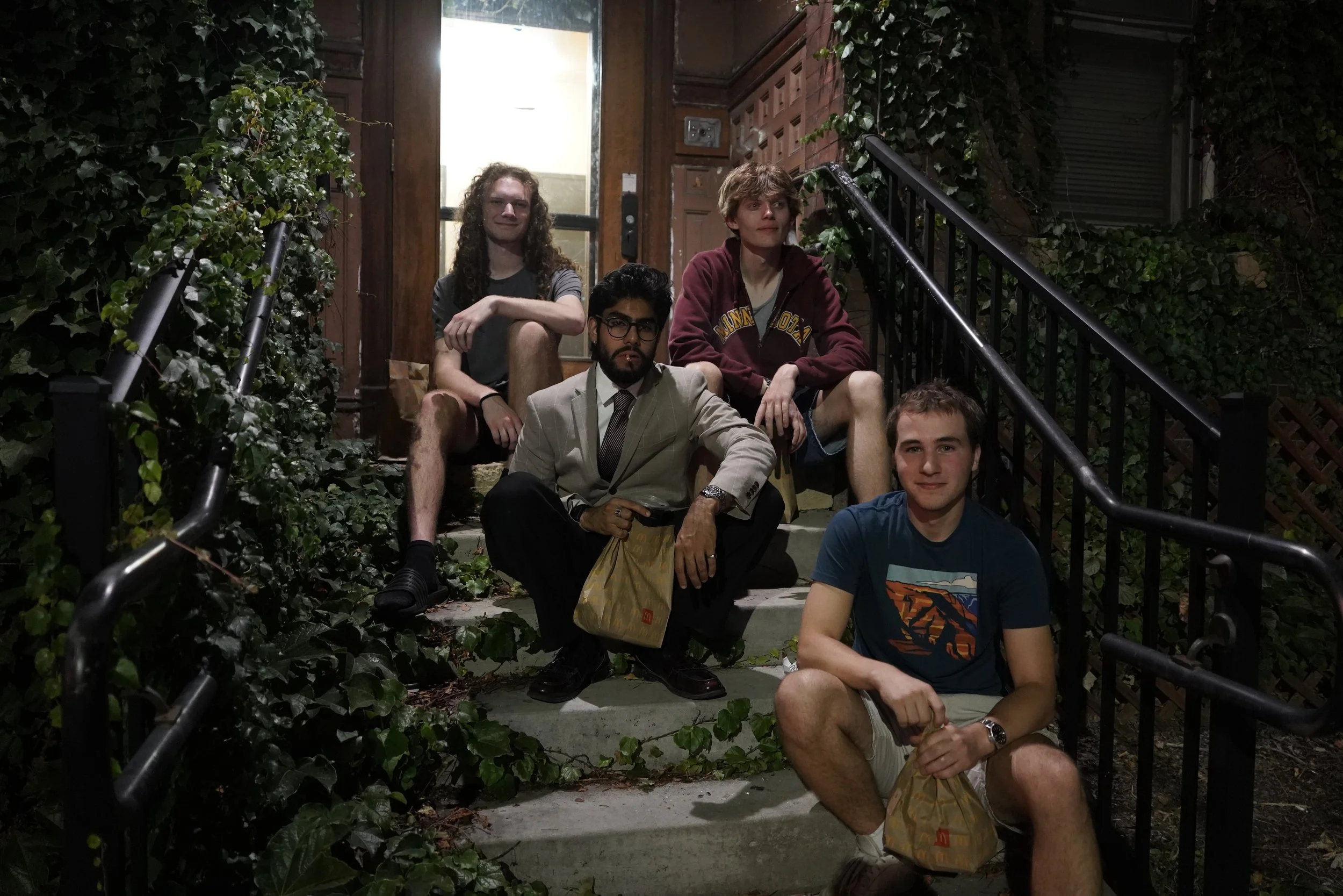 University of Minnesota students Harrison Grant, back left, Caulin Belford, back right, Zayd Naseem, center, and Isiah Theisen pose for a portrait on the front steps of their apartment building in Minneapolis, Minn., on Sept. 29, 2025. The four of th