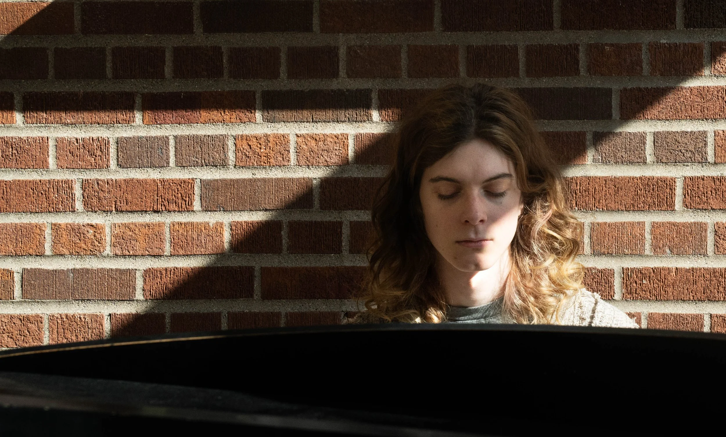 Nursing student and pianist Allie Gilbert sits for a portrait while playing the piano at Coffman Memorial Union at the University of Minnesota in Minneapolis, Minn. on Feb. 26, 2026. Gilbert said the first instrument she learned was the cello, but sh