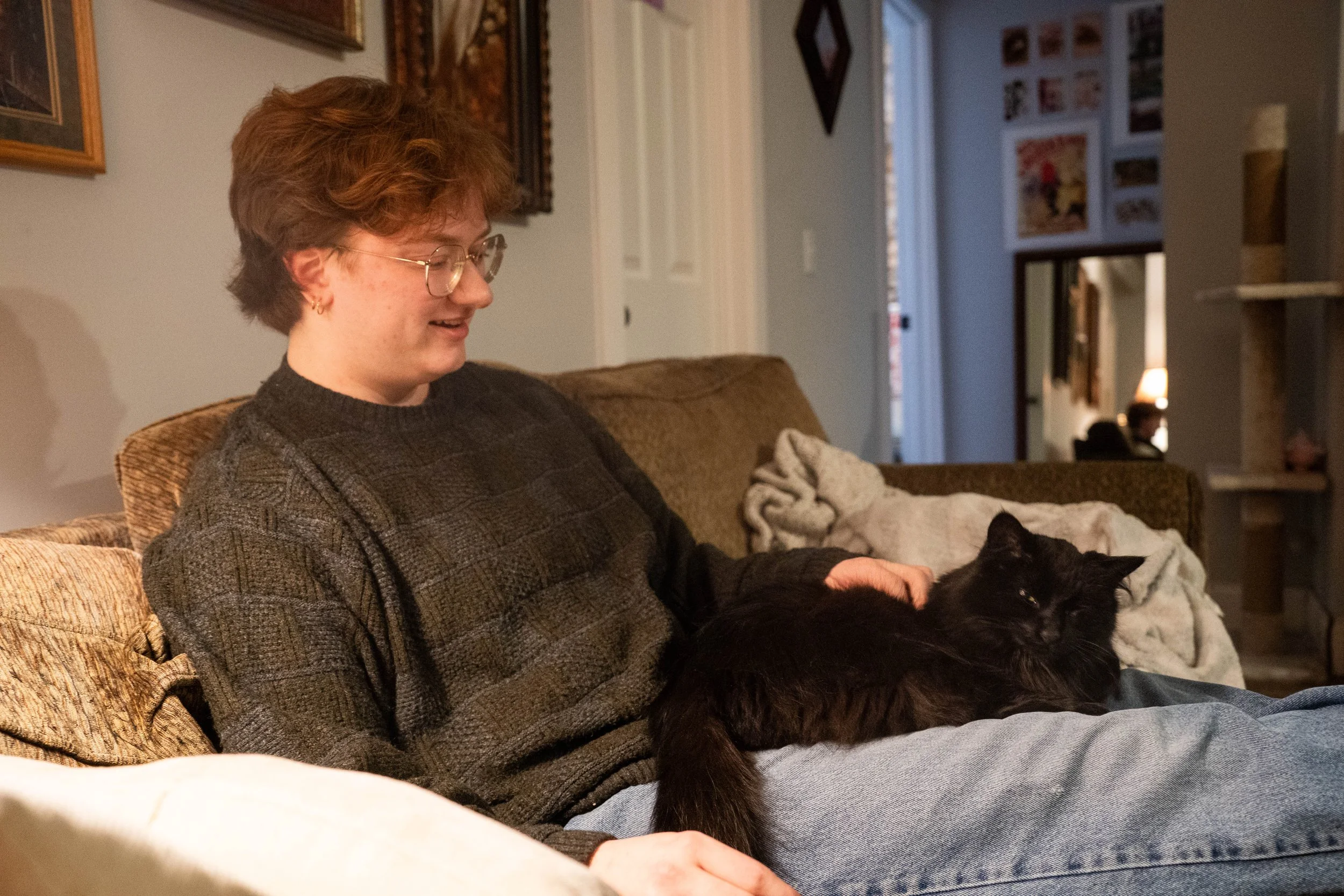 Theater arts and history double major Marsh Kelly and his cat in Kelly's home in Minneapolis, Minn. on Feb. 18, 2026. 