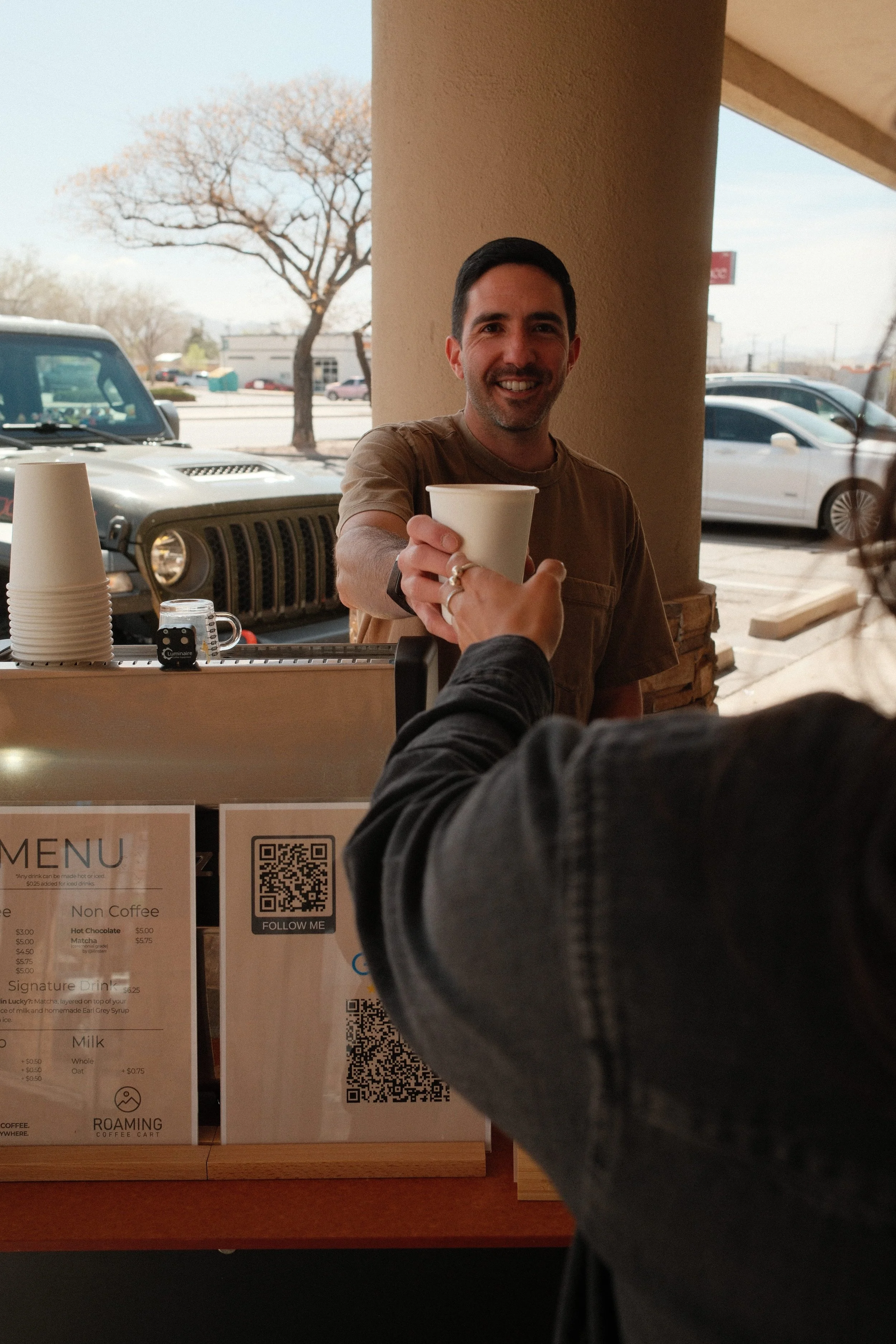 Matt serving coffee drink with a smile. 
