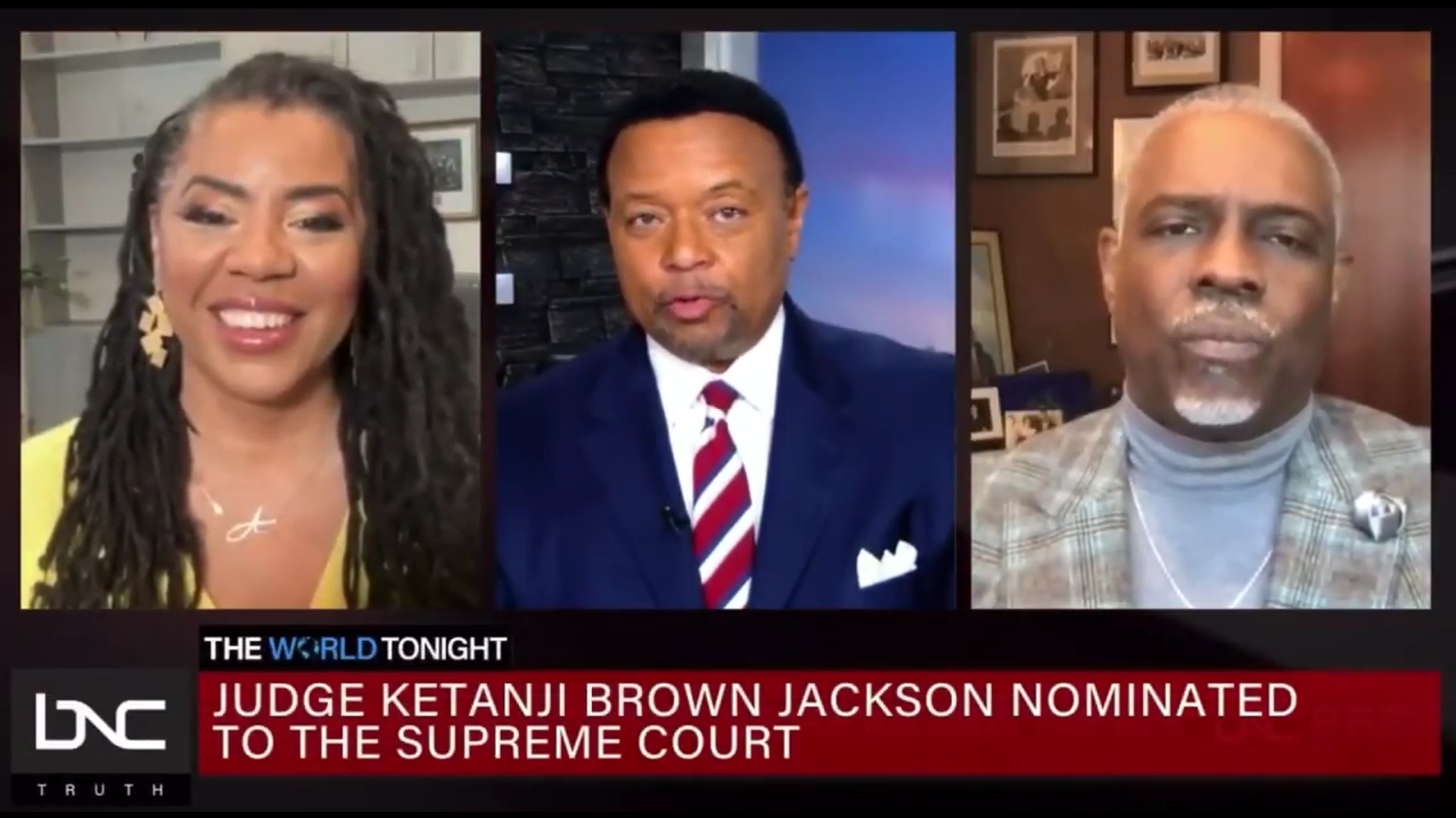 Three news anchors appear on a split-screen TV news broadcast. The left anchor is a woman with braided hair, wearing a yellow top. The middle anchor is a man with short black hair, wearing a dark suit with a white shirt and striped tie. The right anchor is a man with gray hair, wearing a checked blazer. The on-screen text reads 'Judge Ketanji Brown Jackson nominated to the Supreme Court.'