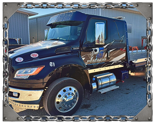A car on a tow truck at sunset with a chain border around the image.