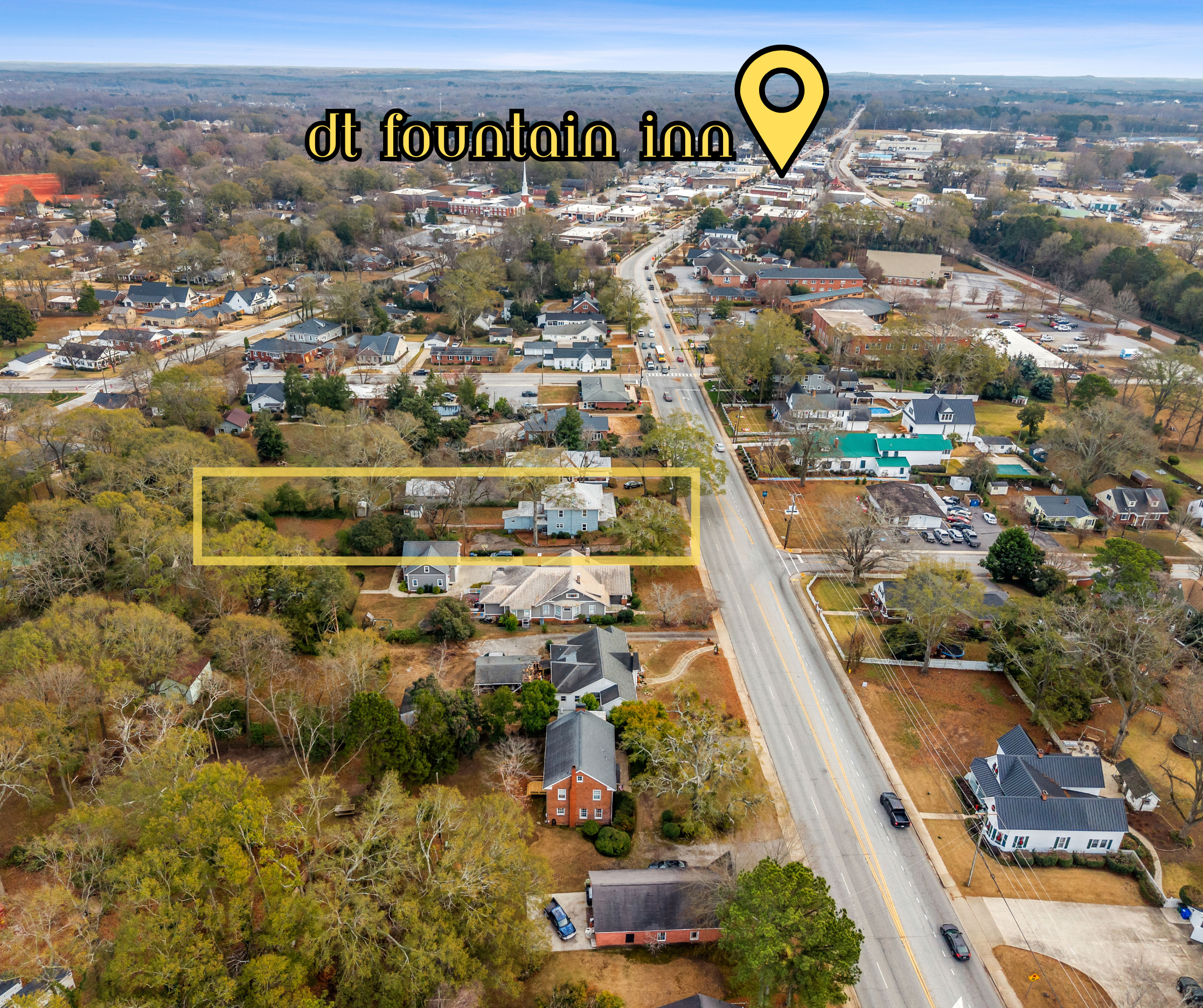 Aerial view of a suburban neighborhood with houses, trees, and streets. The image highlights a specific property with a yellow rectangle surrounding it and a location marker near the top labeled 'dt fountain inn'.