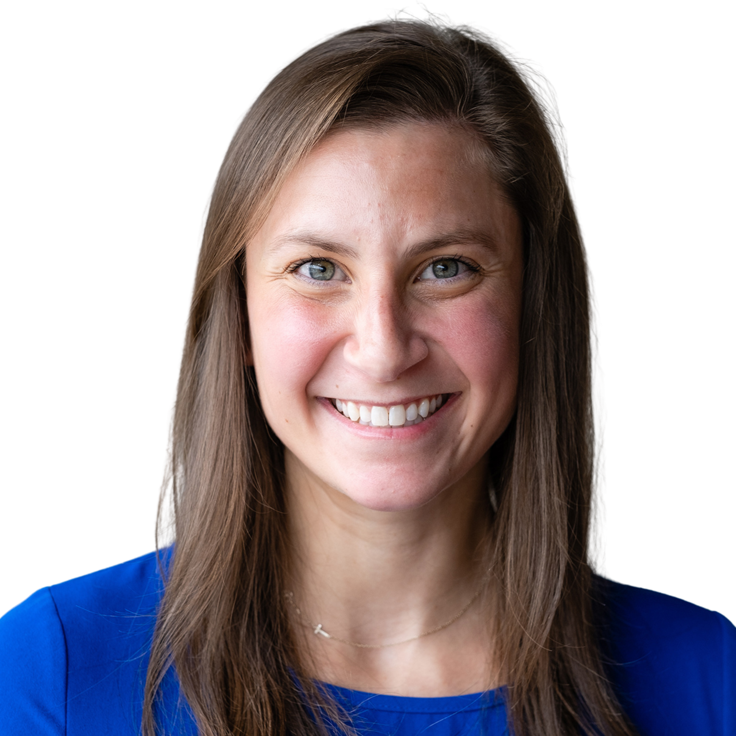 Close-up of a smiling woman with long brown hair wearing a blue top and a delicate necklace.