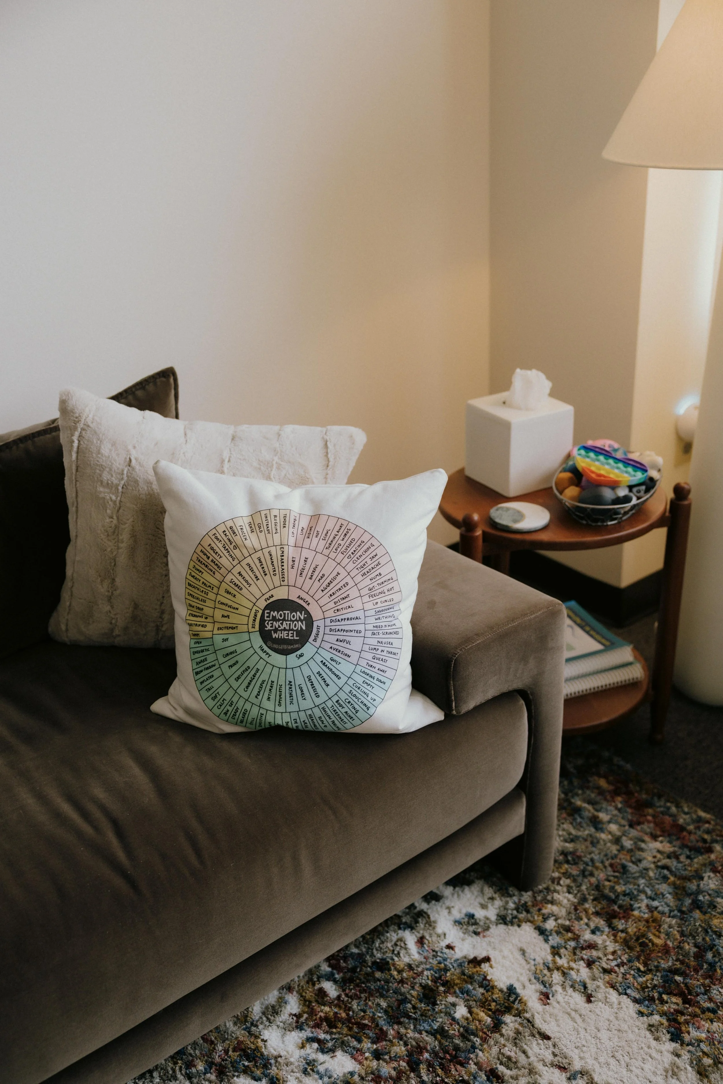 Emotion Sensation Wheel pillow on couch in therapy office