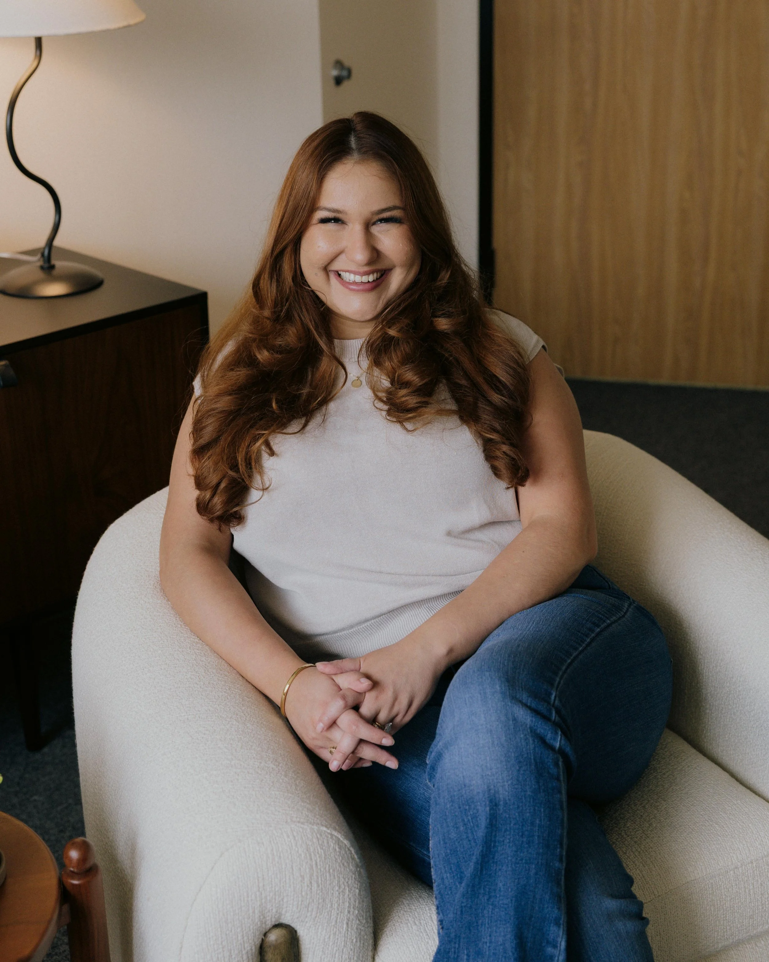 Gabriela Trevino sitting in therapy office with warm, welcoming posture