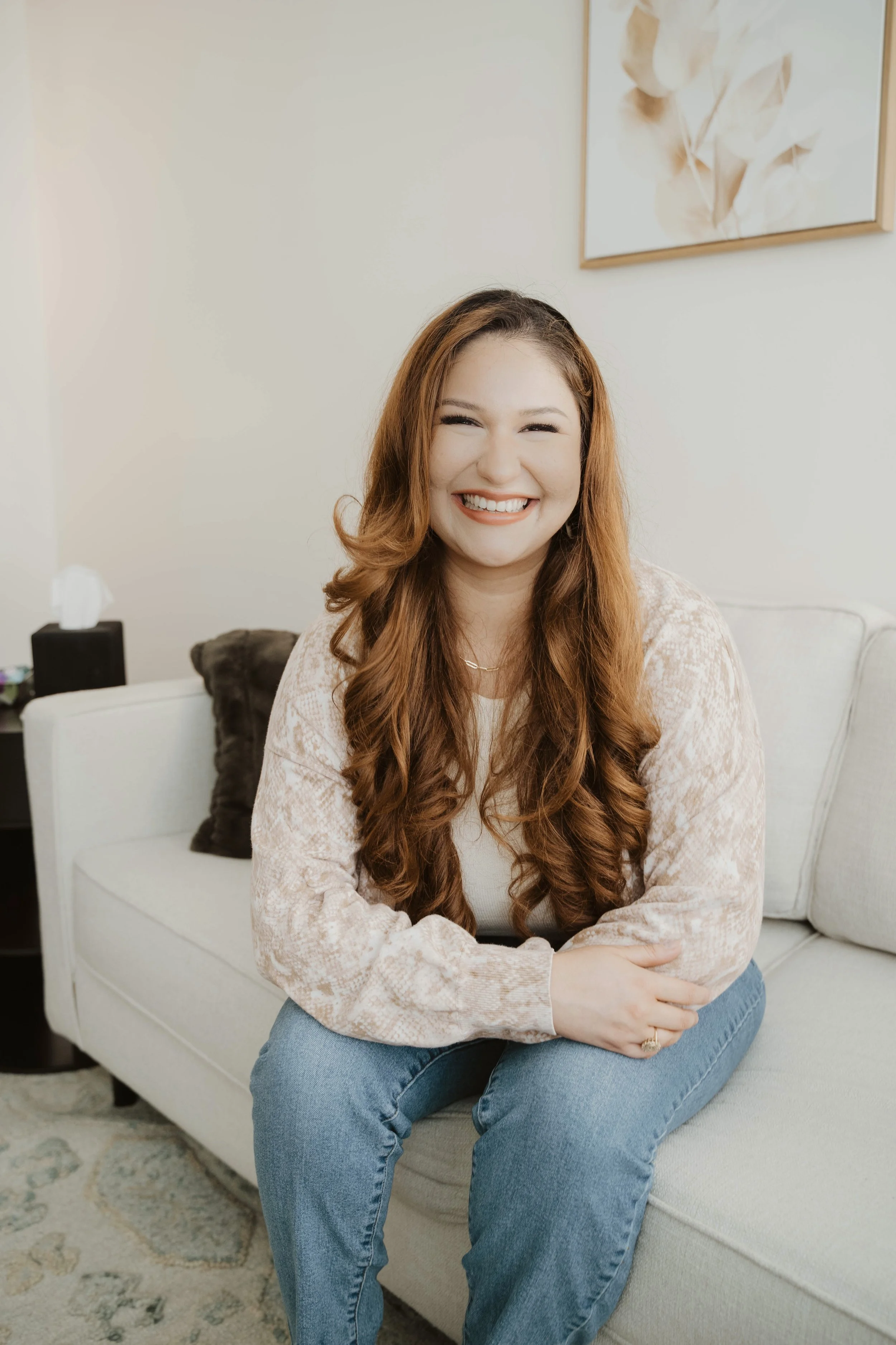Gabriela Trevino sitting in therapy office with a warm and welcoming body language.