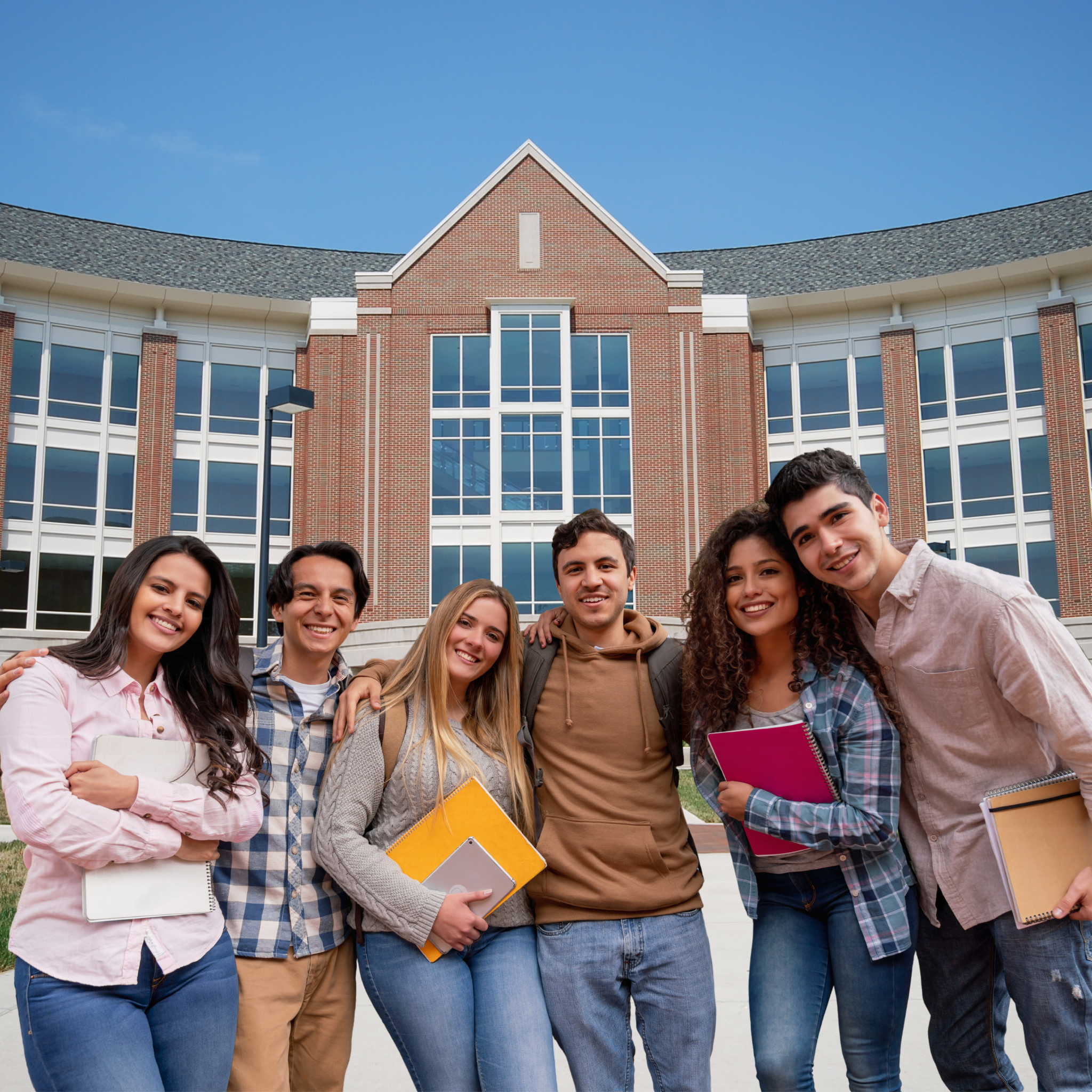 group of diverse college students smiling outside a university building