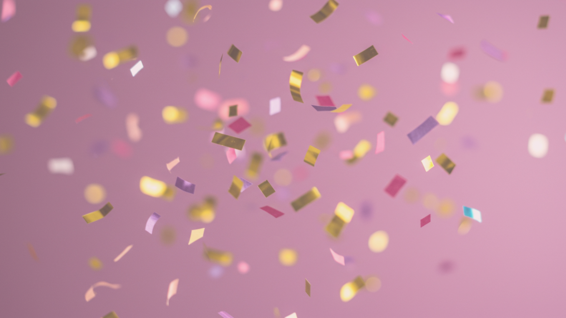 Confetti falling against a pink background.