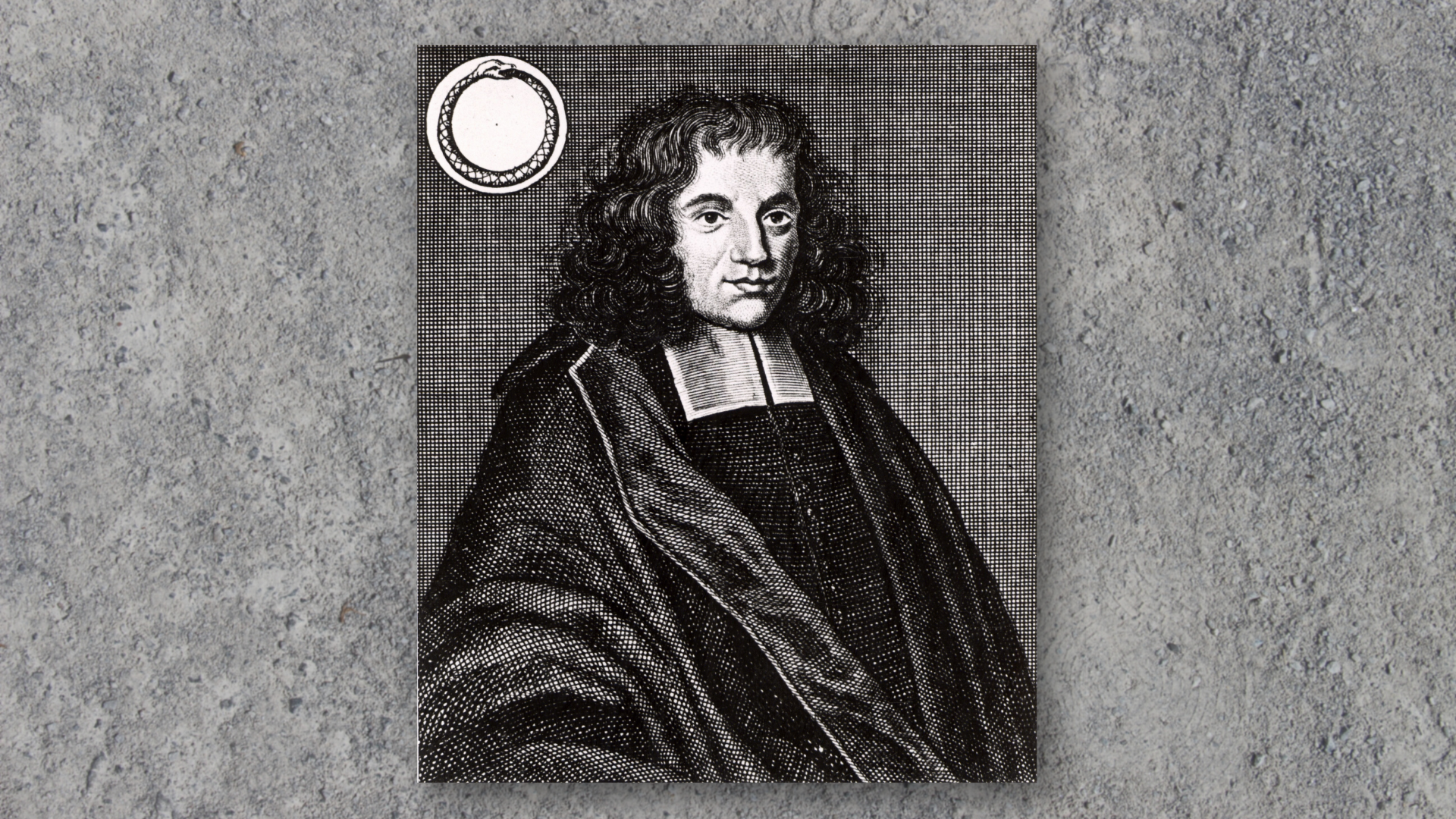 An engraving of a man (Benedictus de Spinoza, aka Baruch Spinoza) with dark curly hair cut just above the shoulders, wearing a robe with large, loose arms and two white squares of fabric at the top of his dark shirt.