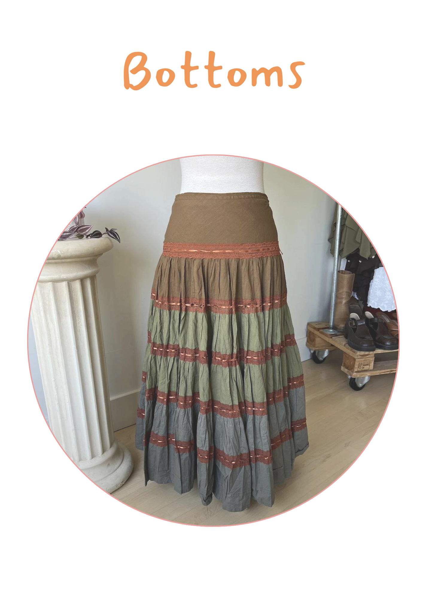 Colorful tiered maxi skirt on a mannequin, featuring earthy tones of brown, green, and gray with red accents.