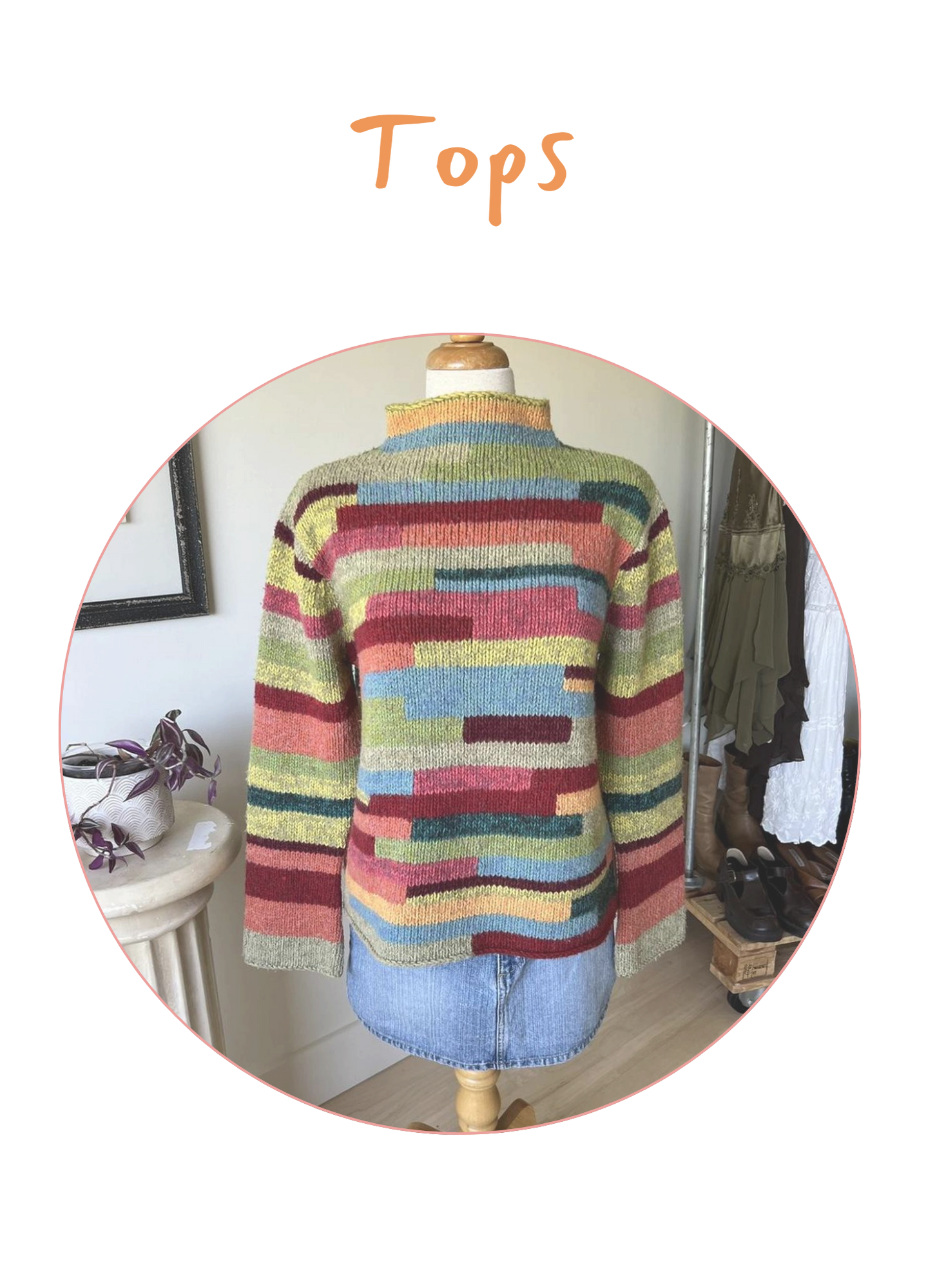 Colorful striped knit sweater displayed on a mannequin, with a denim skirt at the bottom. The background shows a corner of a room with a small table, a plant, a mirror, and some clothing and shoes.