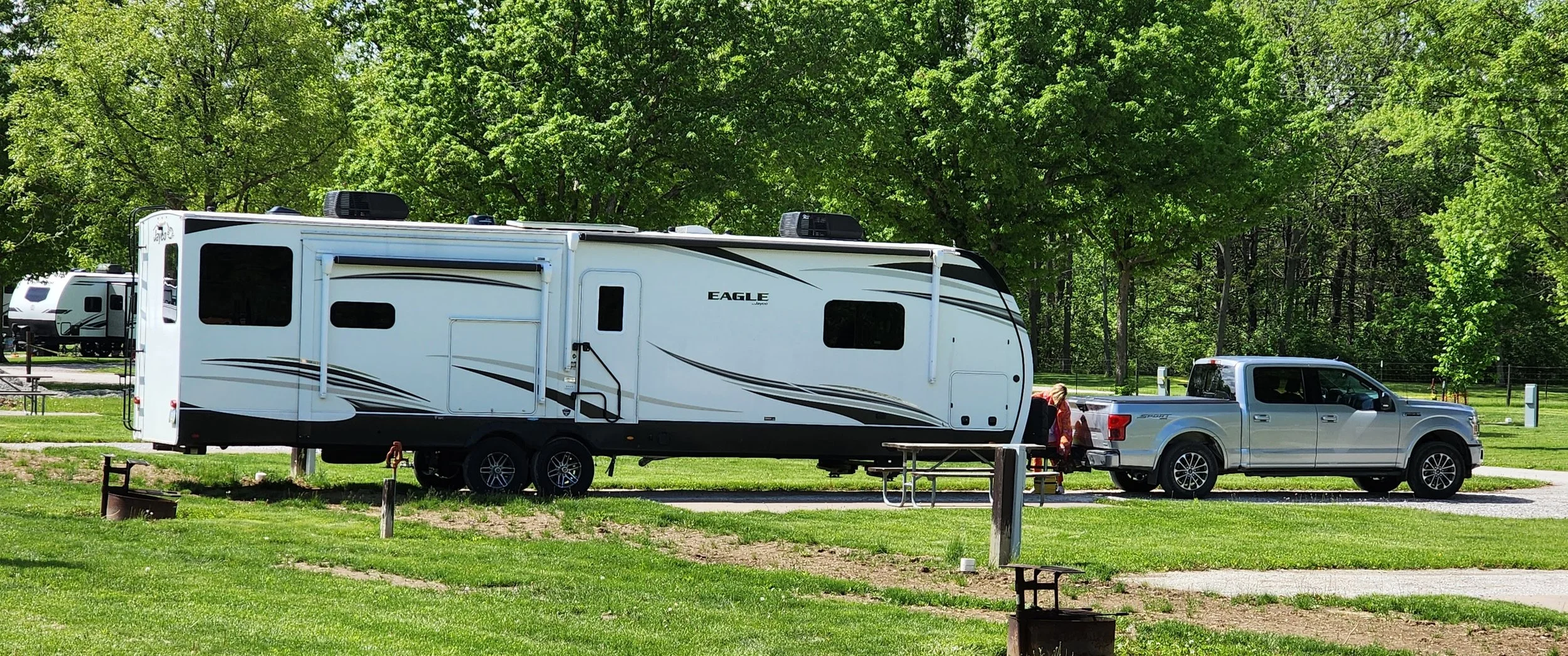 A silver Ford F150 tows a very large Jayco Eagle travel trailer.