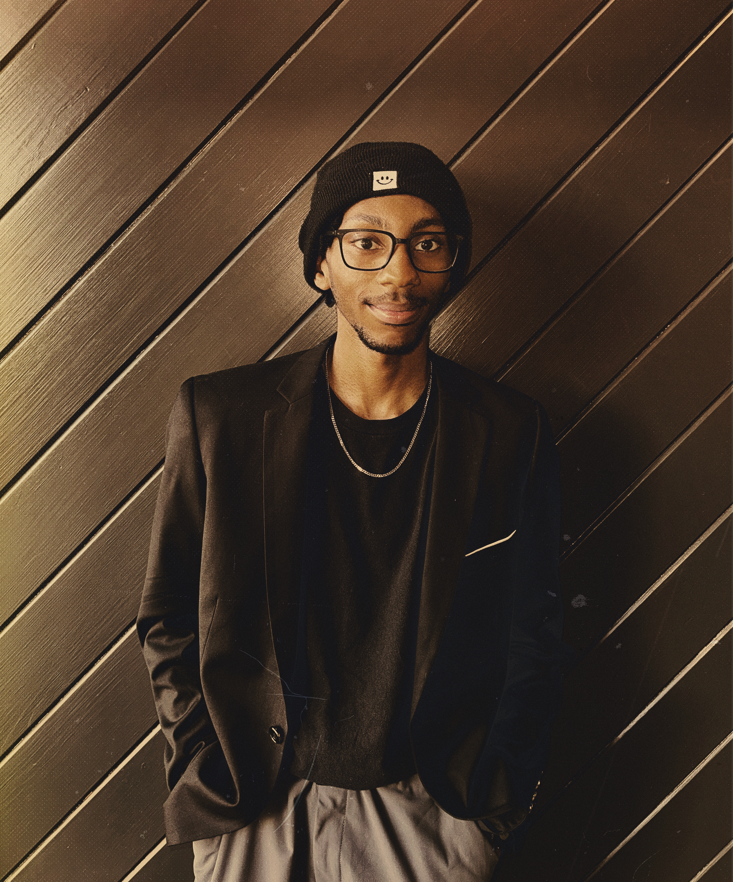 Image of Young Lad standing Infront of a wall