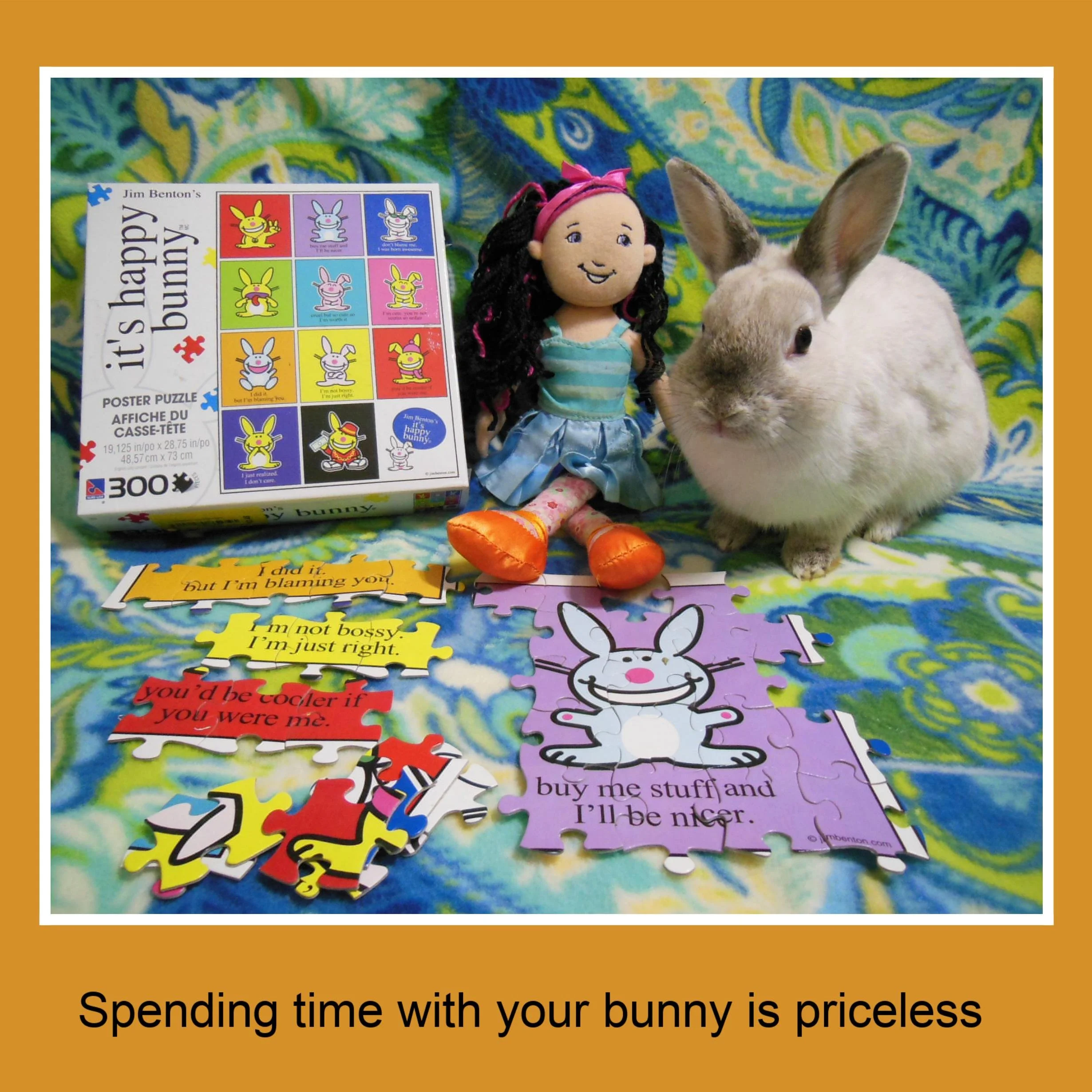 A plush doll, a rabbit, a puzzle with bunny illustrations, and some colorful puzzle pieces with bunny-related phrases on a patterned fabric background.