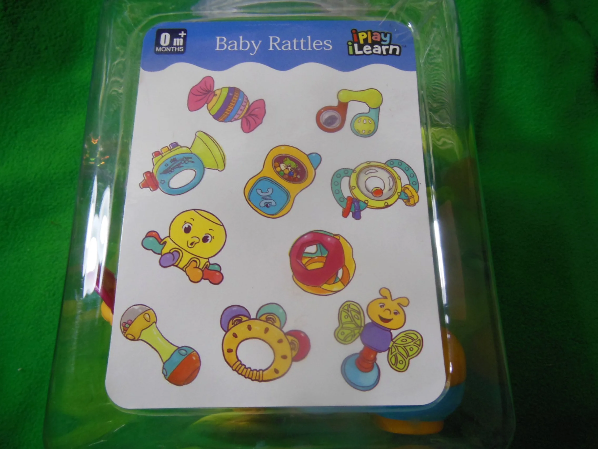 Sticker sheet with illustrations of baby rattles and toys, labeled 'Baby Rattles' and 'iPlay iLearn' in the top right corner.