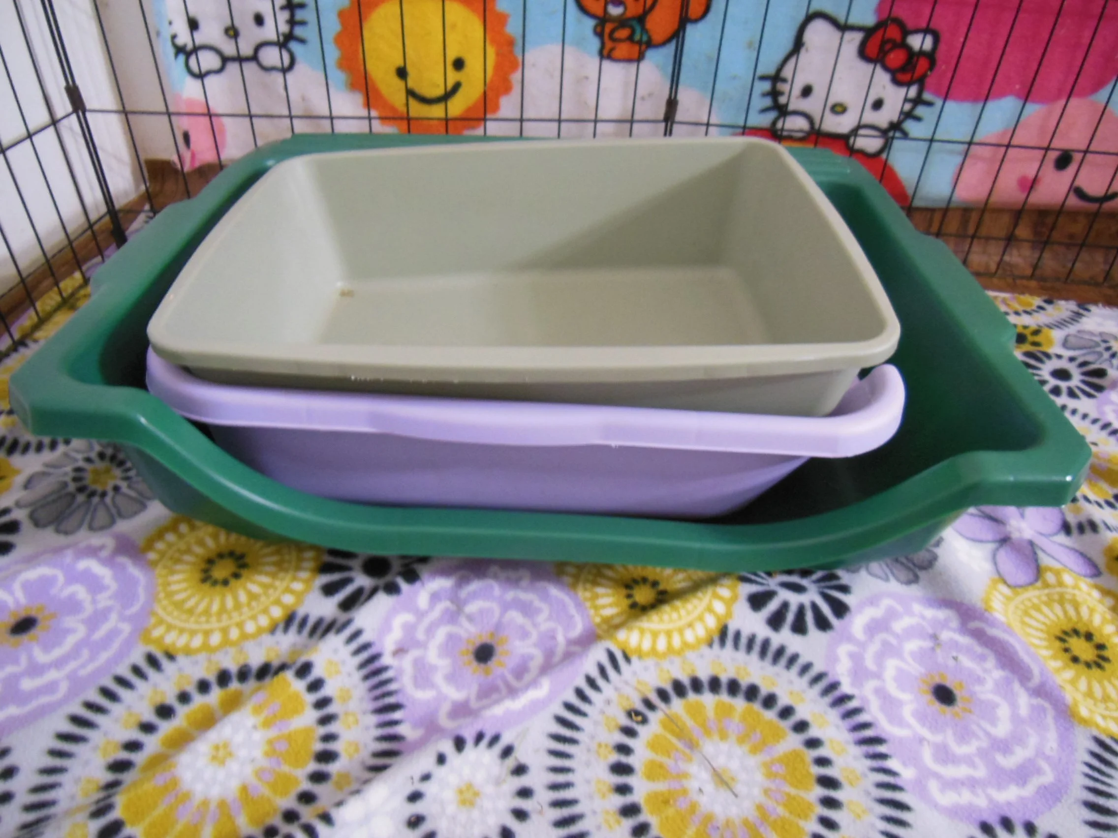various litter boxes stacked together to show size difference